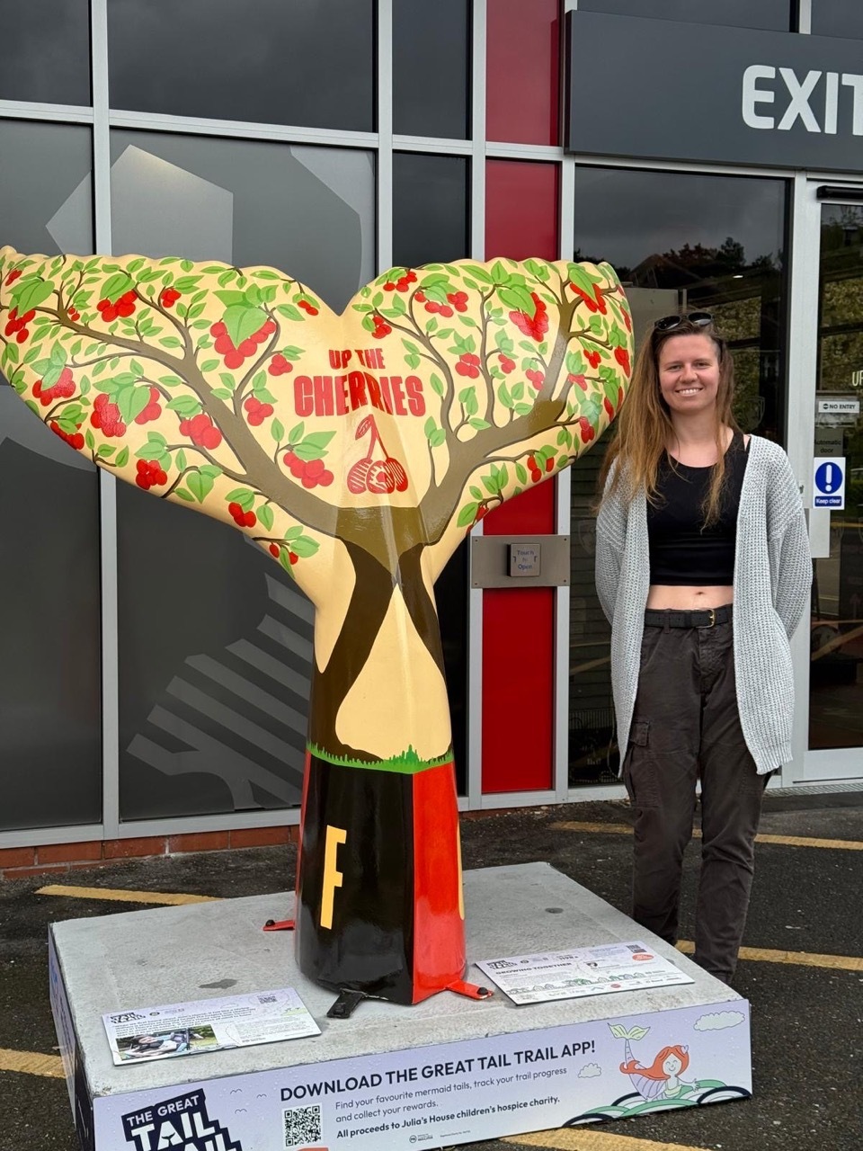 L'Eisha Haywood stood with her painted Bournemouth Cherries tail outside of AFC Bournemouth.