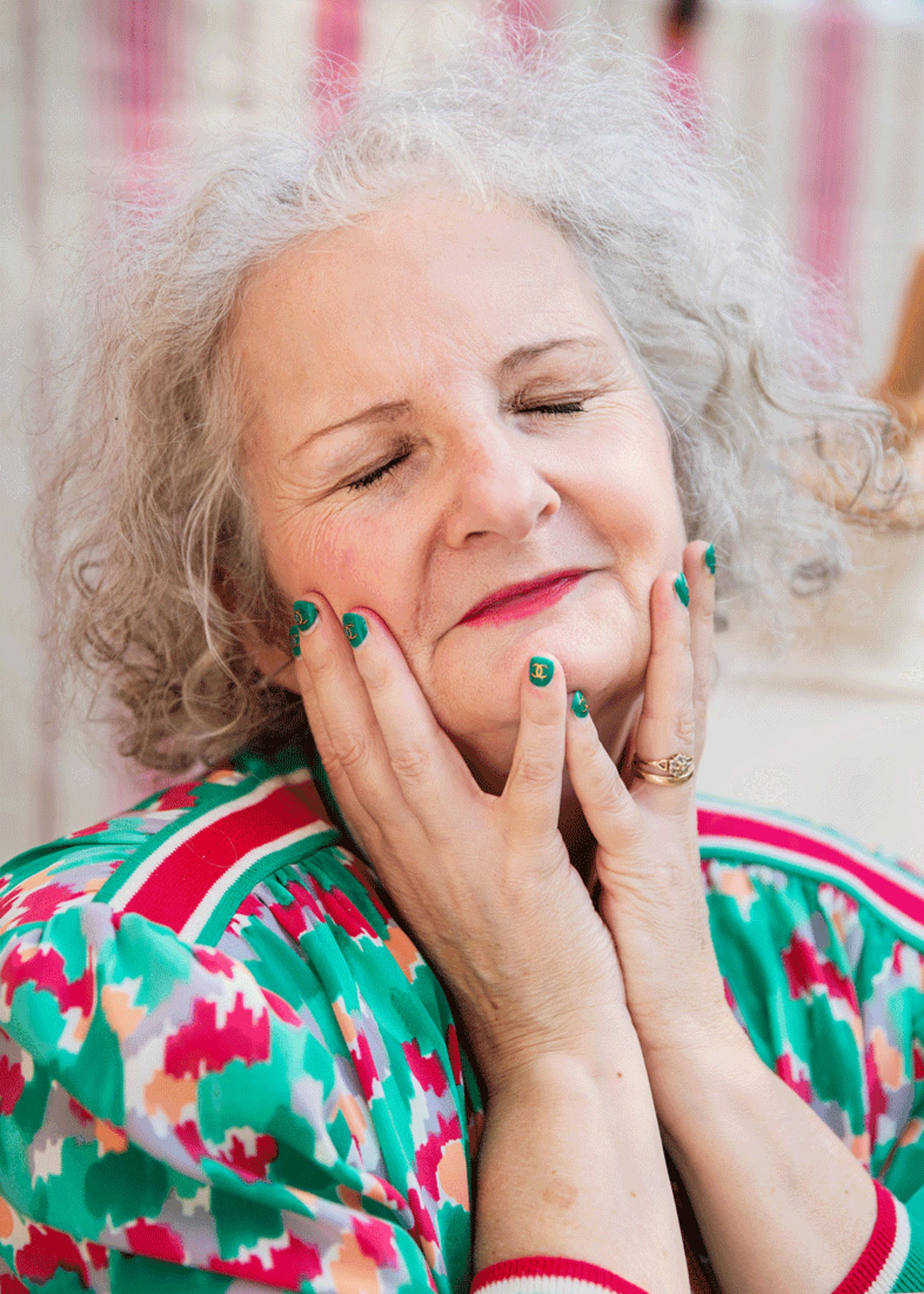 Woman with her eyes closed clutching her face with her hands