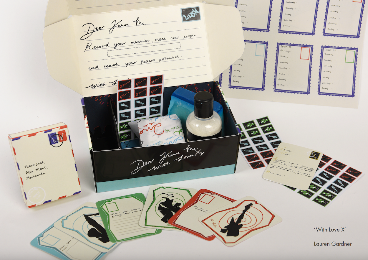 A packaging design open with its contents laid out of a table, including a notepad, cards and stamps with musical instruments on them.
