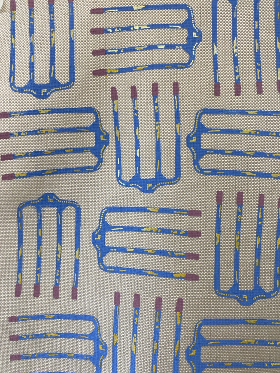 A patterned fabric featuring a repeating design of blue hand forks with purple handles, arranged in a grid format. The background is a light beige with subtle texture.