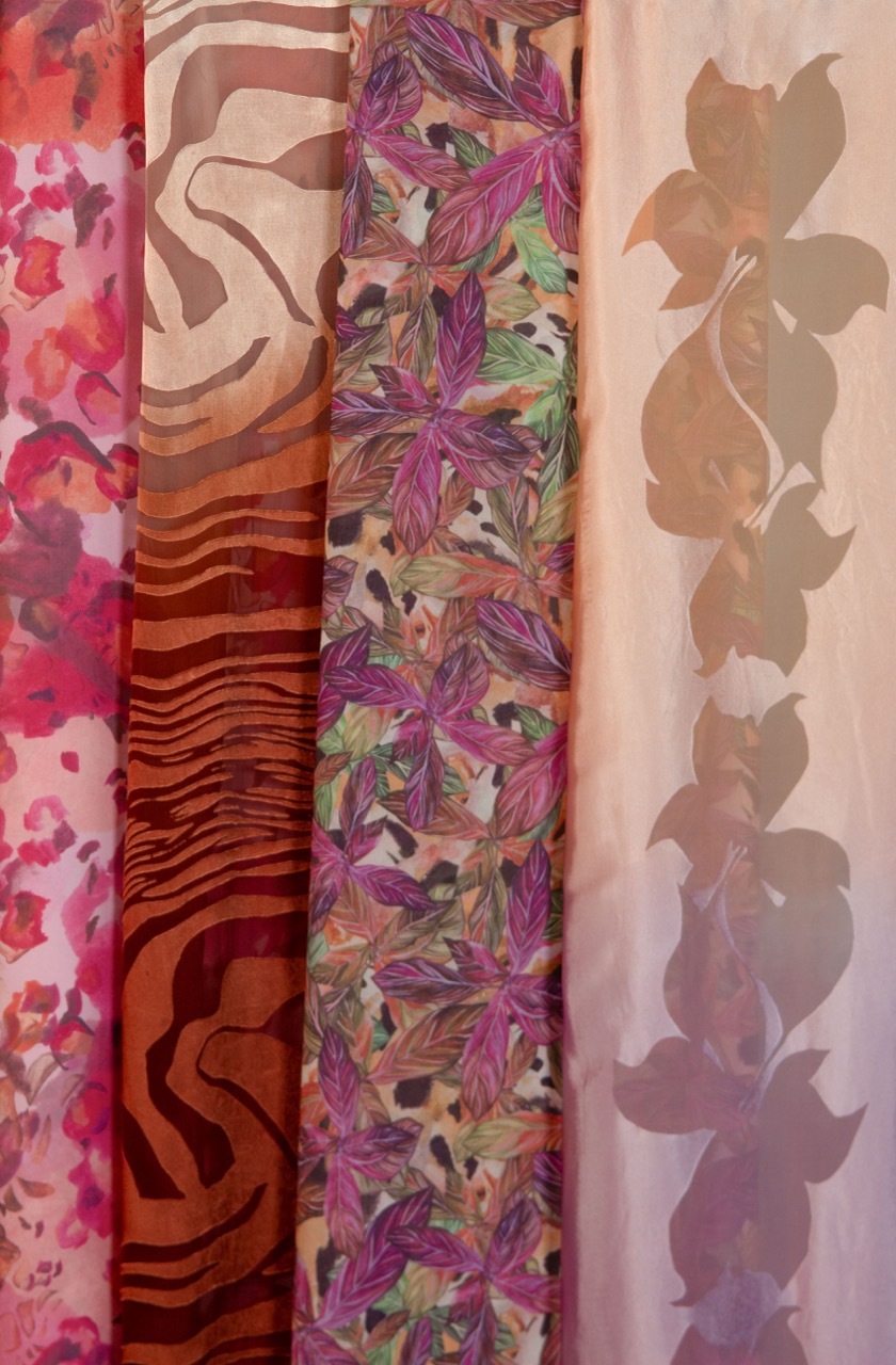 Five vertical fabric strips with different patterns: pink florals, brown zebra stripes, purple tropical leaves, and brown botanical silhouettes.