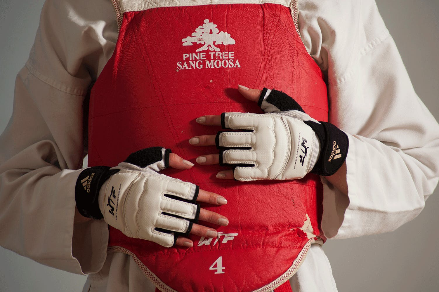 Female martial artist wearing body protection padding