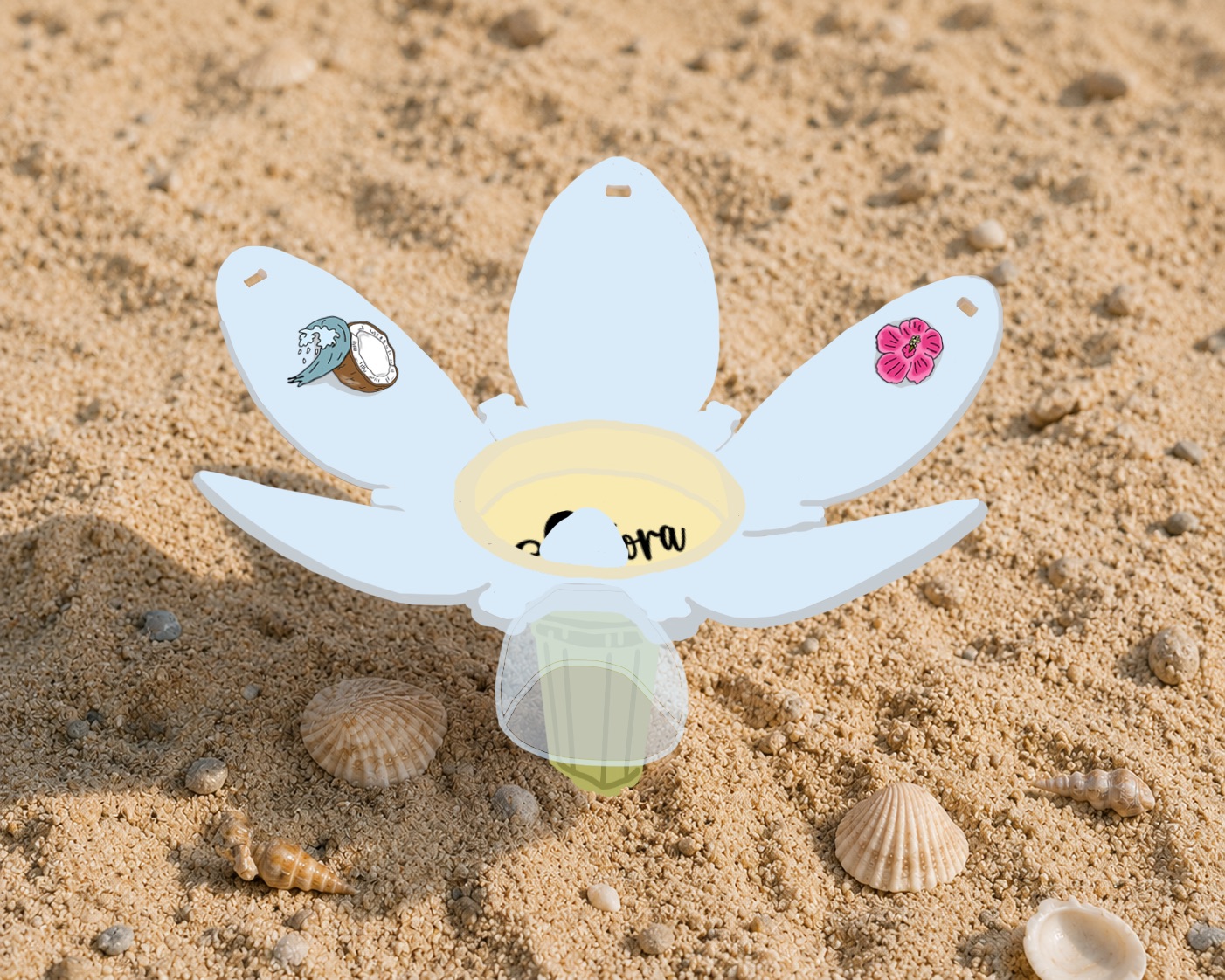 A white flower-shaped beach lantern with shell decorations and a small glass candle holder, placed on sand with scattered seashells.