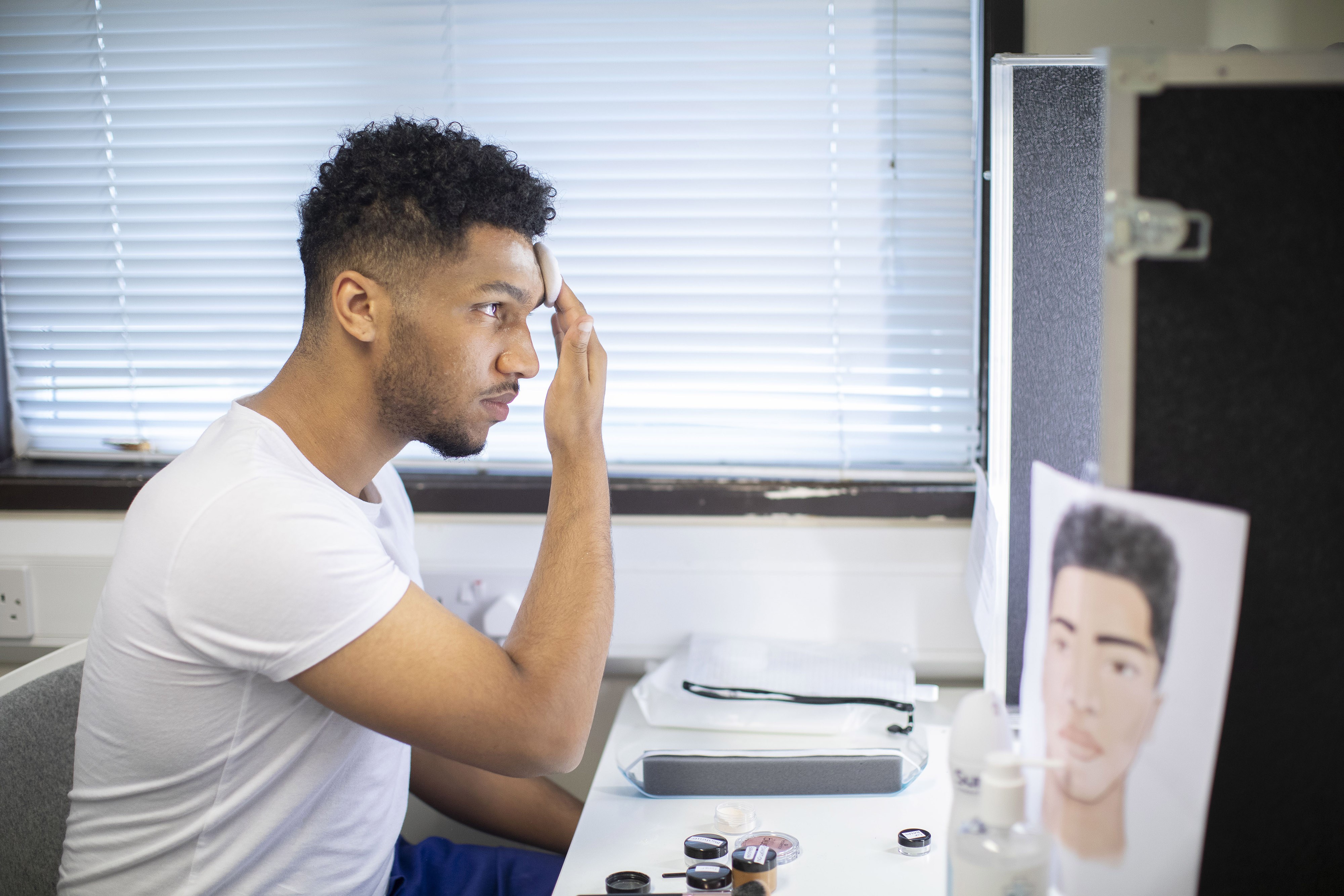 Acting student putting on make-up