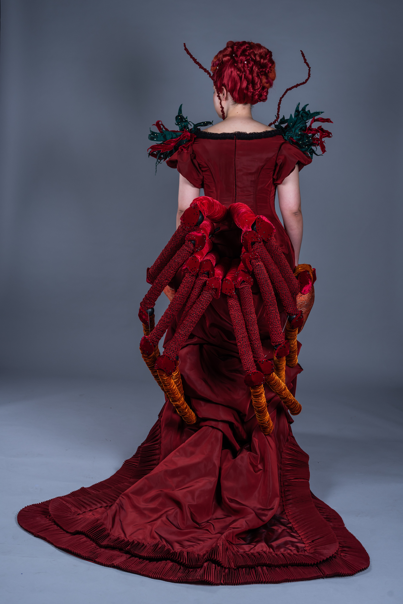 Model photographed from the back wearing a costume inspired by a lobster.