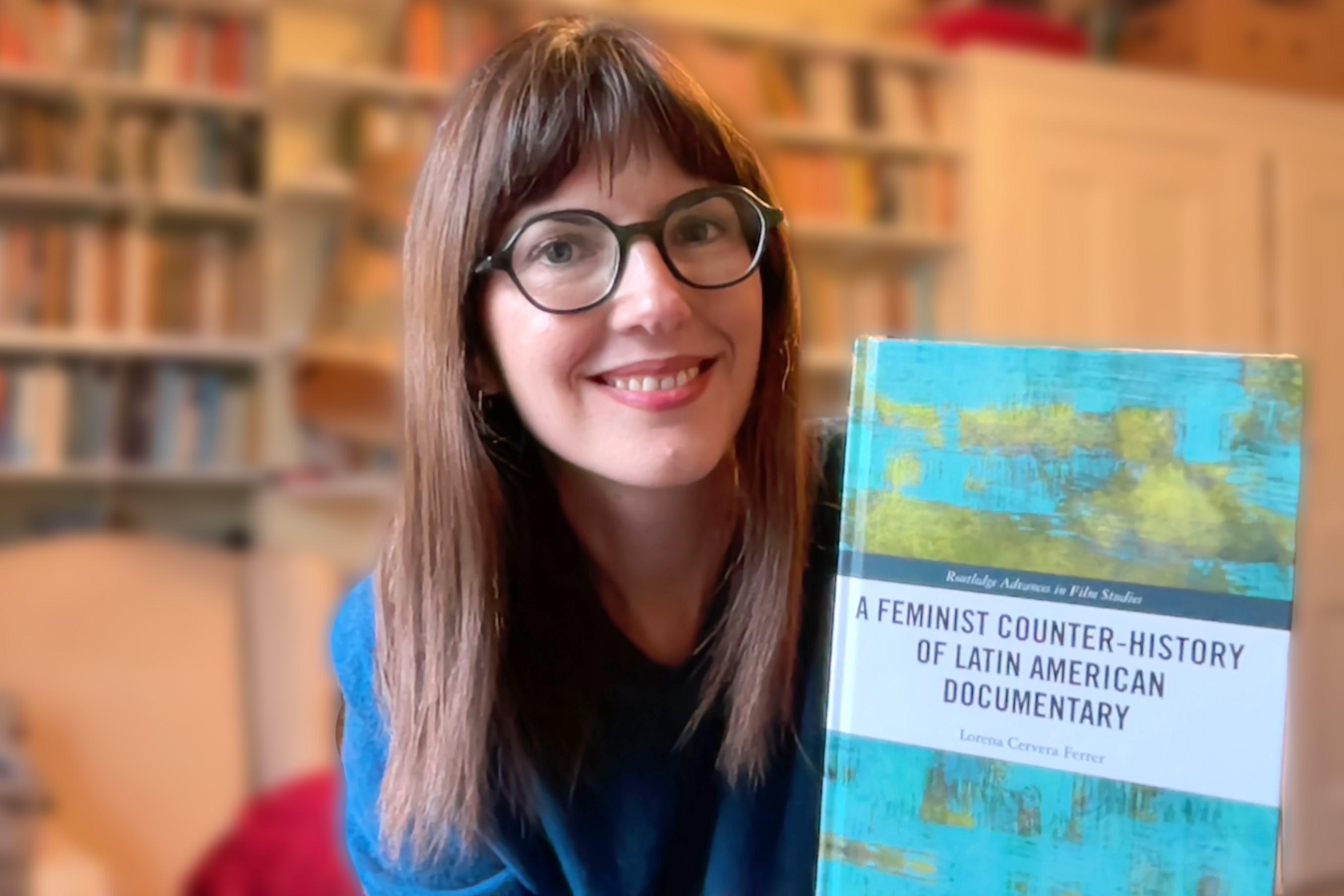 Headshot of Dr L Cervera with copy of her book "A Feminist Counter-History of Latin American Documentary"