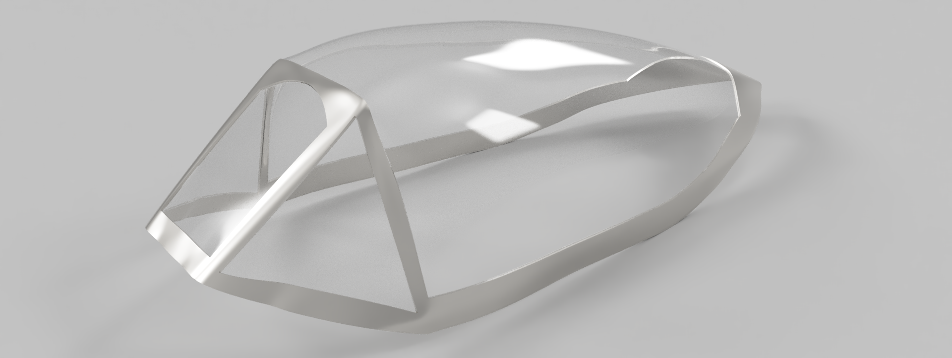 A transparent, aerodynamic shell model positioned at an angle, featuring smooth curves and a pointed front. The structure is set against a grey background, highlighting its reflective surface and sleek design.
