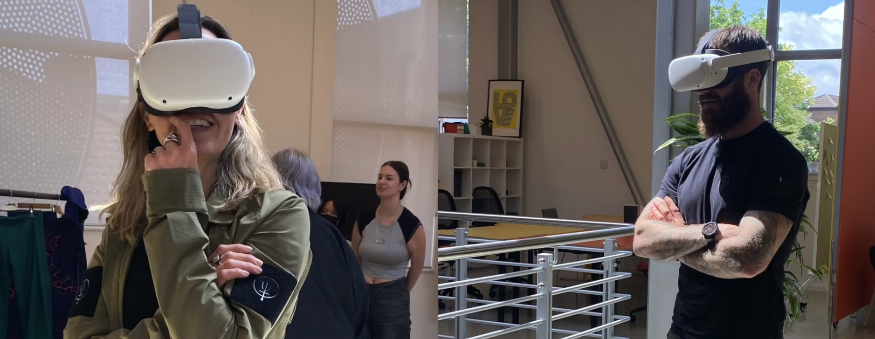 Two people wearing white VR headsets in modern office space with metal railings and large windows