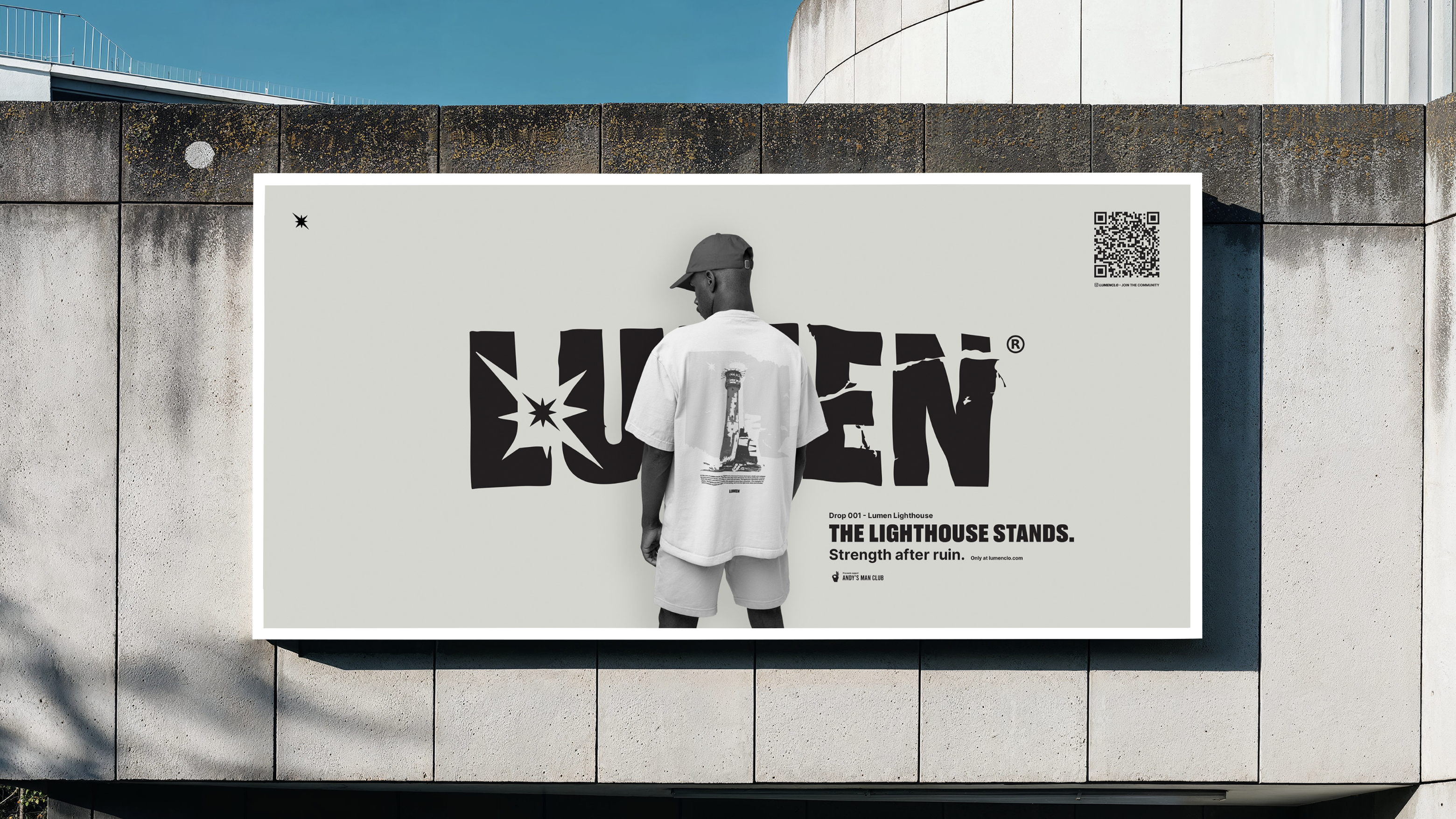A man wearing an oversized white T-shirt and cap stands facing a large billboard with the word 'LUXTEN', mounted on a concrete wall beside a curved building.