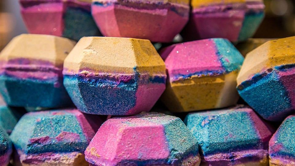 Colourful Lush bath bombs stacked on top of each other