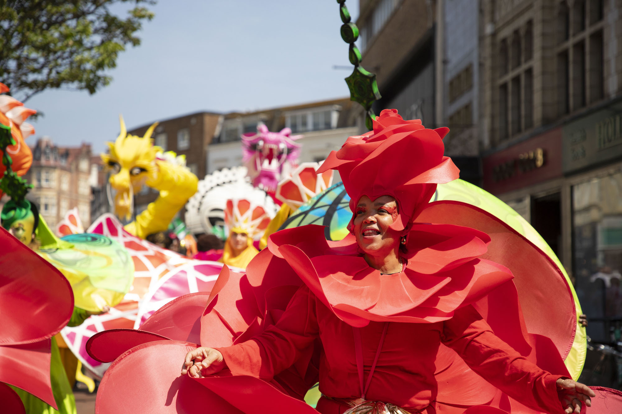 Carnival dancers in colourful flower-inspired costumes performing at Alice in Spring 2024.