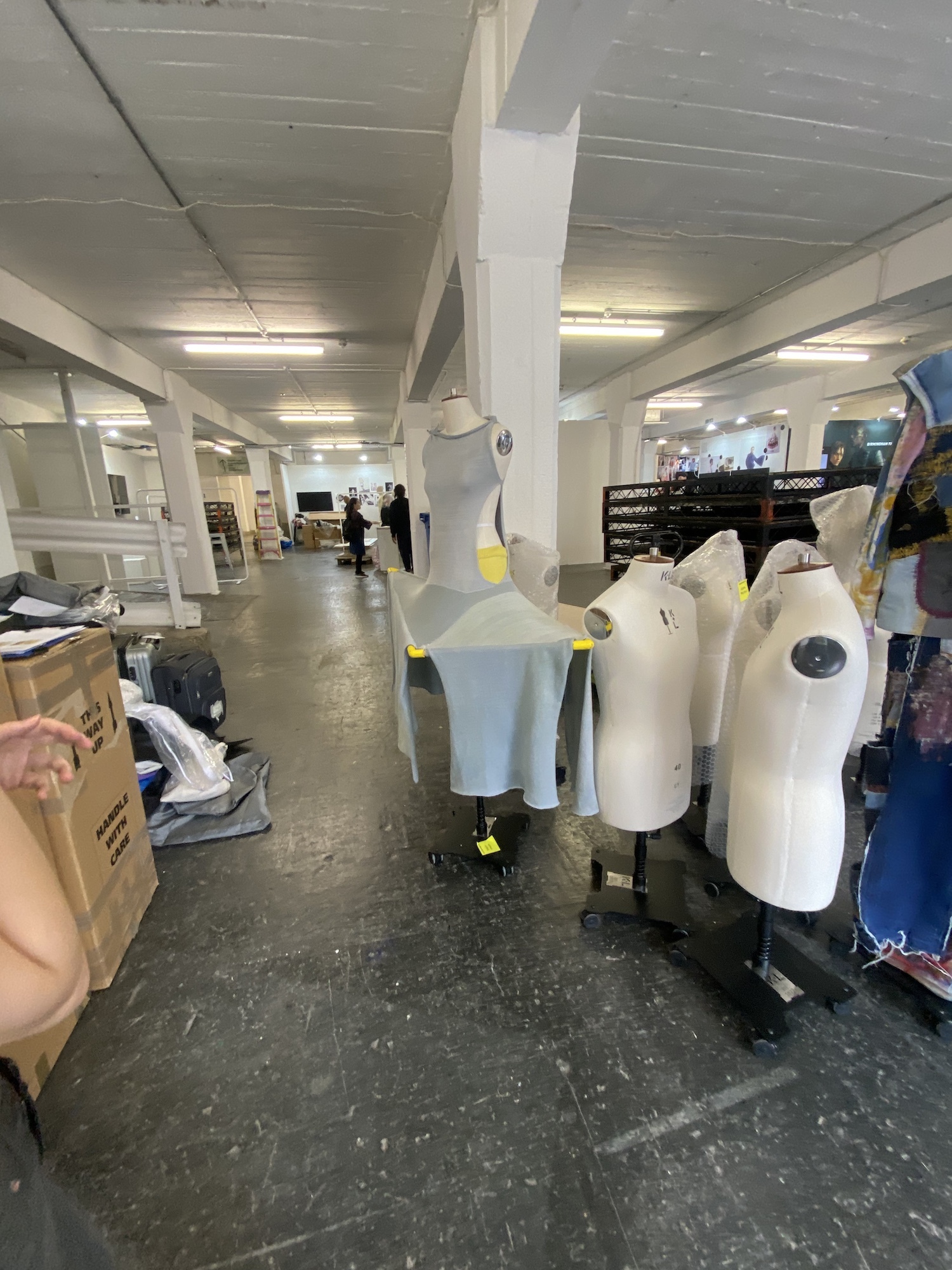 Undressed and partly-dressed mannequins, behind the scenes at Graduate Fashion Week 2024.