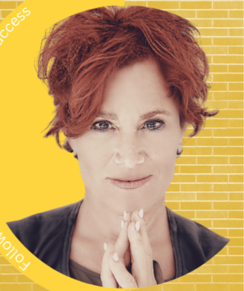 Headshot of M Zeitlin surrounded by a yellow brick wall background.