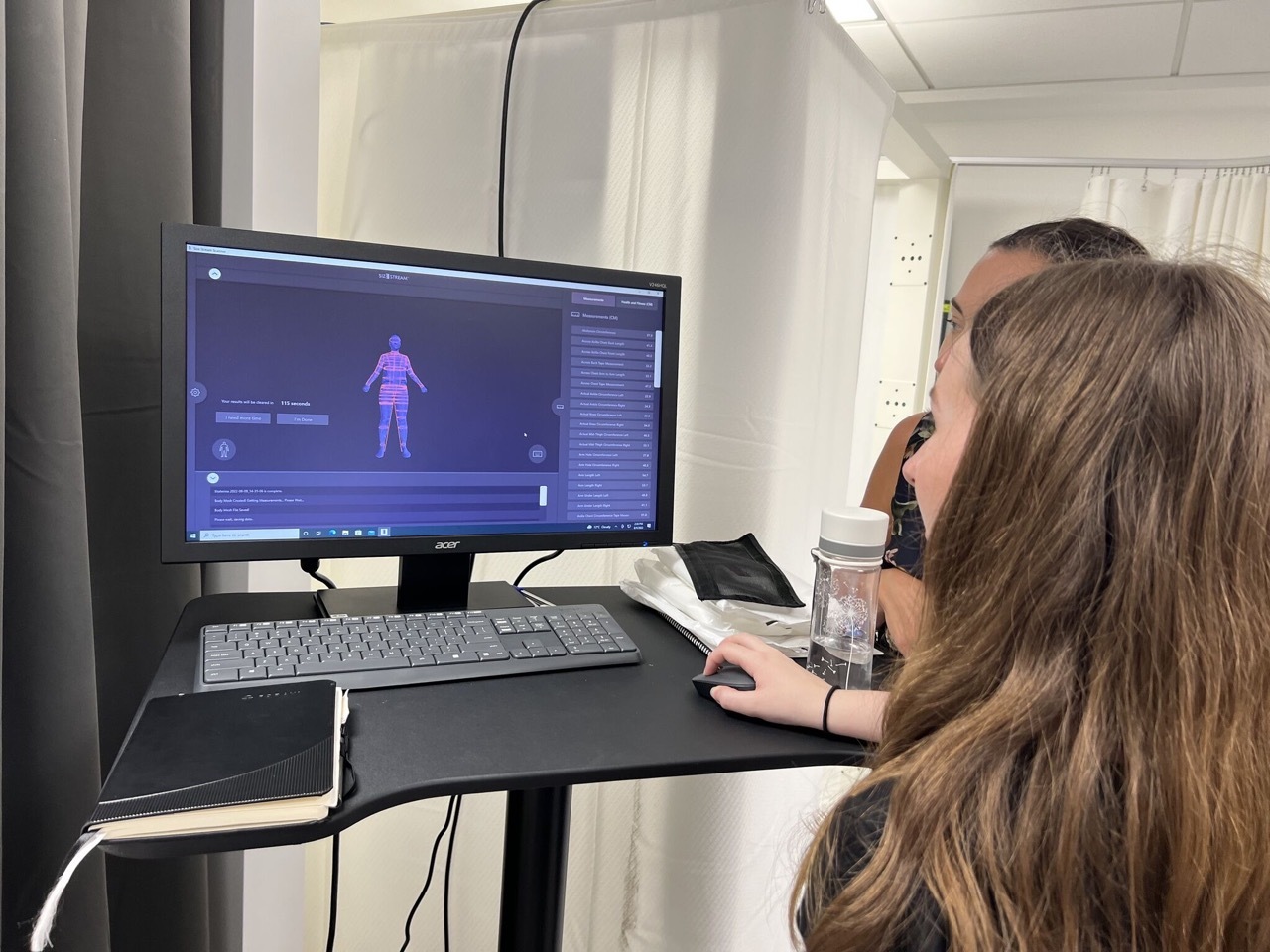 Students working on a computer with body mapping software.