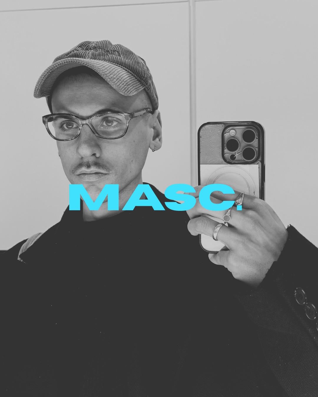A man wearing glasses and a cap takes a mirror selfie with a smartphone, with turquoise “MASC.” text overlaid across the image.