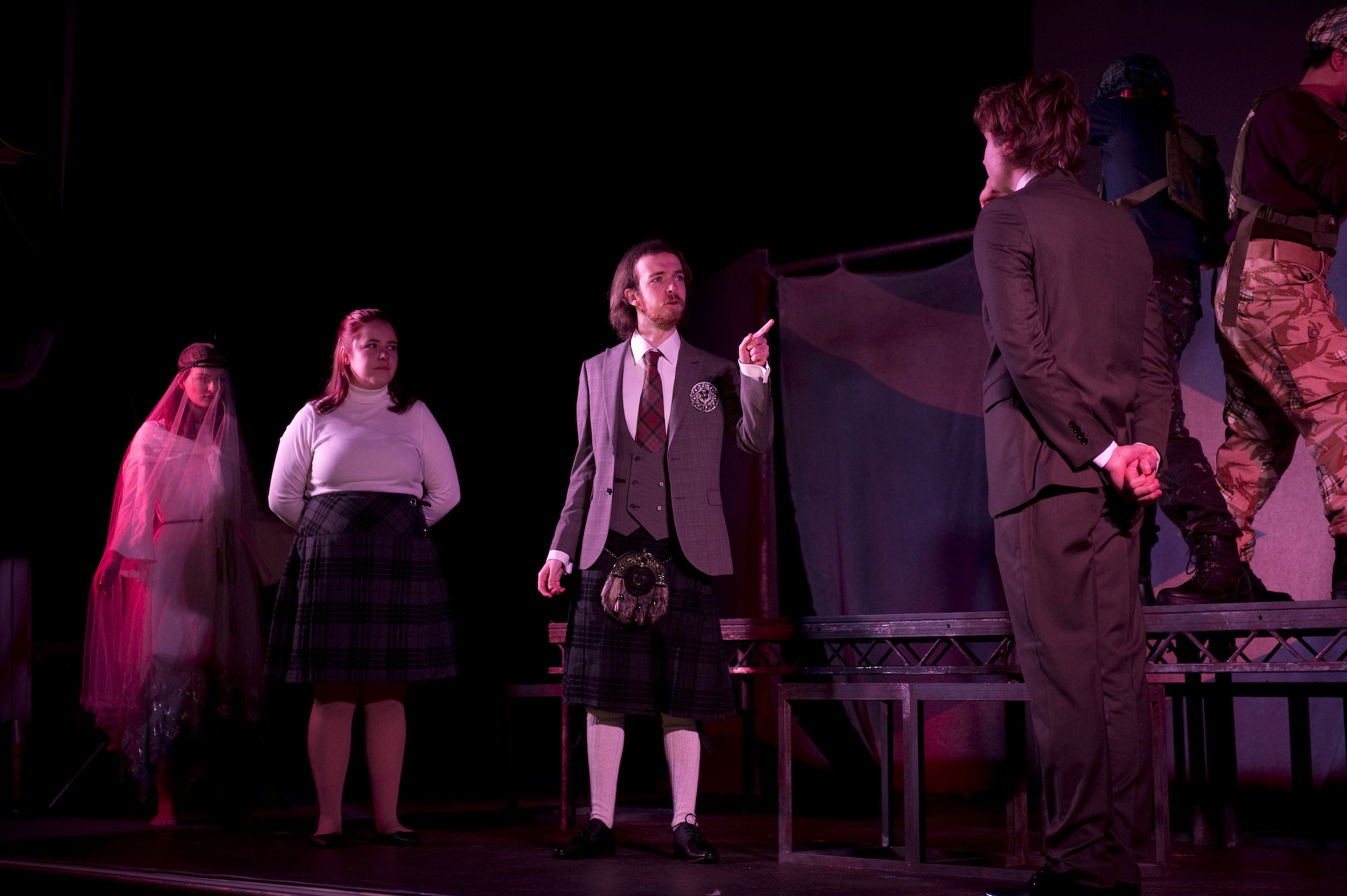 Group of BA (Hons) Acting students on stage performing Macbeth at the Palace Court Theatre.