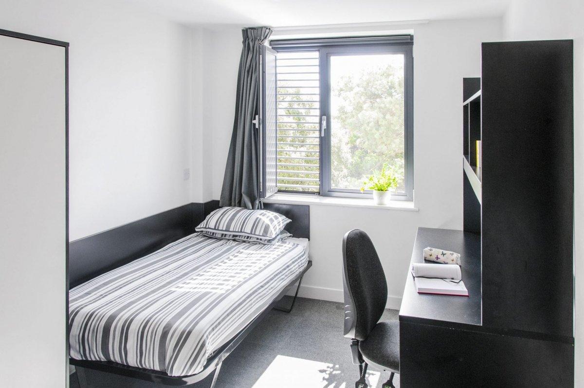 Bedroom featuring a single bed and a black desk and chair