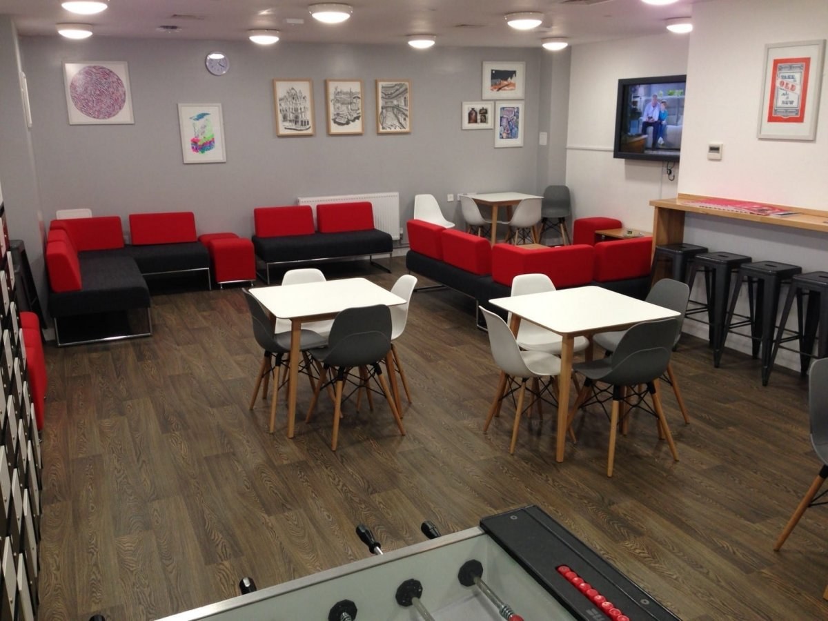 Common Room featuring tables, and sofa setting area with a TV