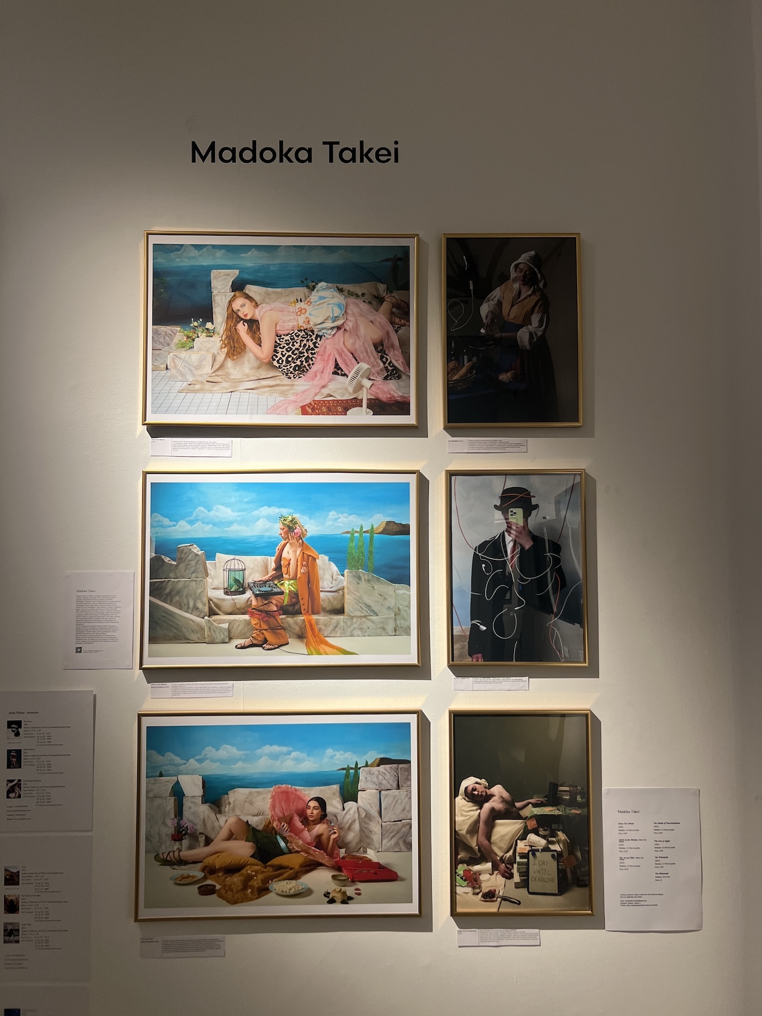 Gallery wall displaying six framed paintings by Madoka Takei, arranged in three rows of two, featuring figures in various settings with bright blues, oranges, and earth tones.