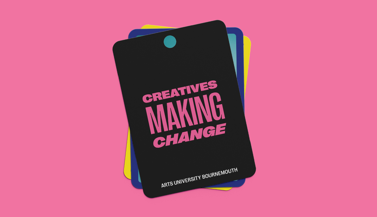 Stack of rectangular cards on pink background. Top black card displays 'CREATIVES MAKING CHANGE' in pink and blue text with teal circle.