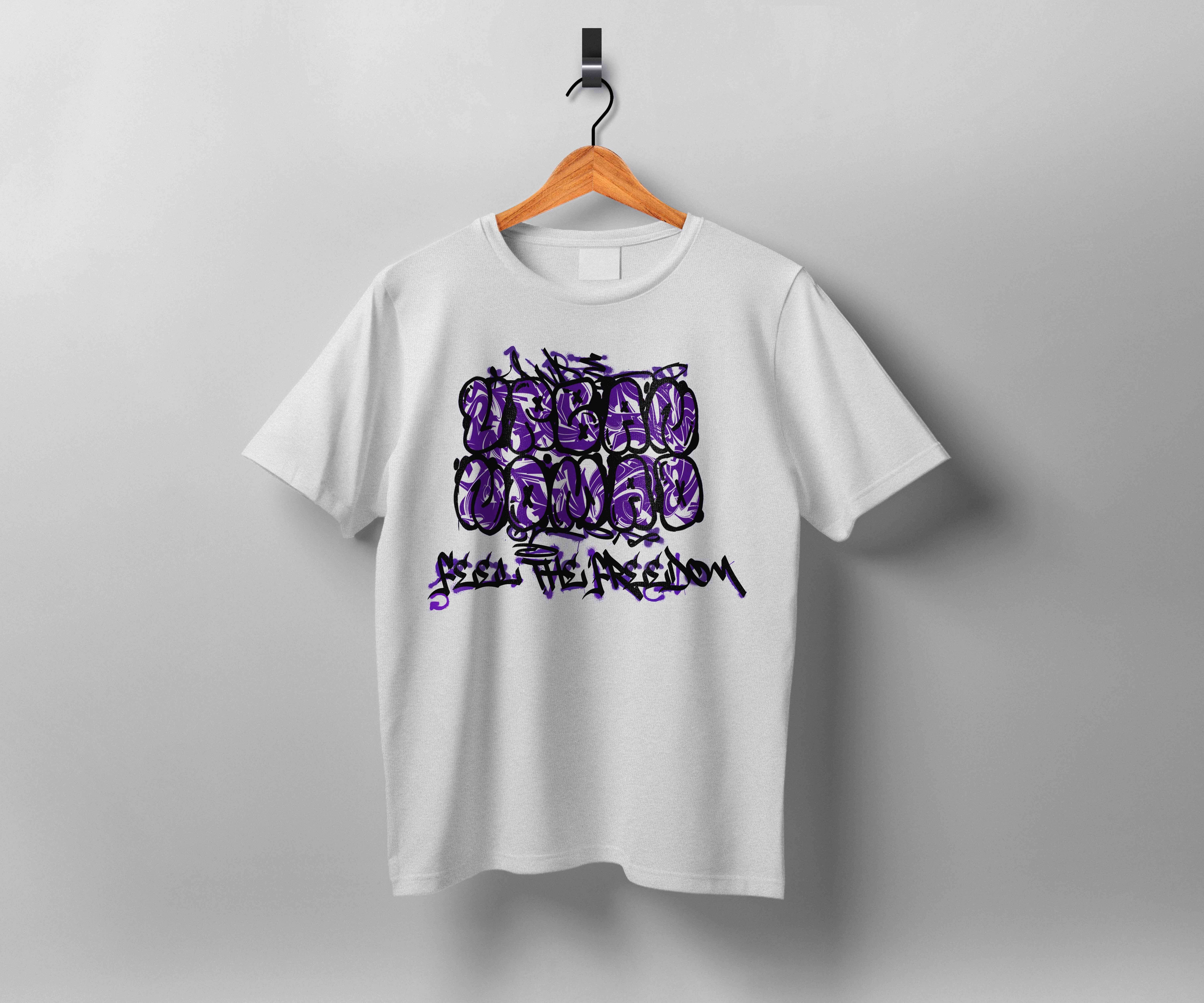 White t-shirt on wooden hanger displaying purple graffiti-style text design against grey background.