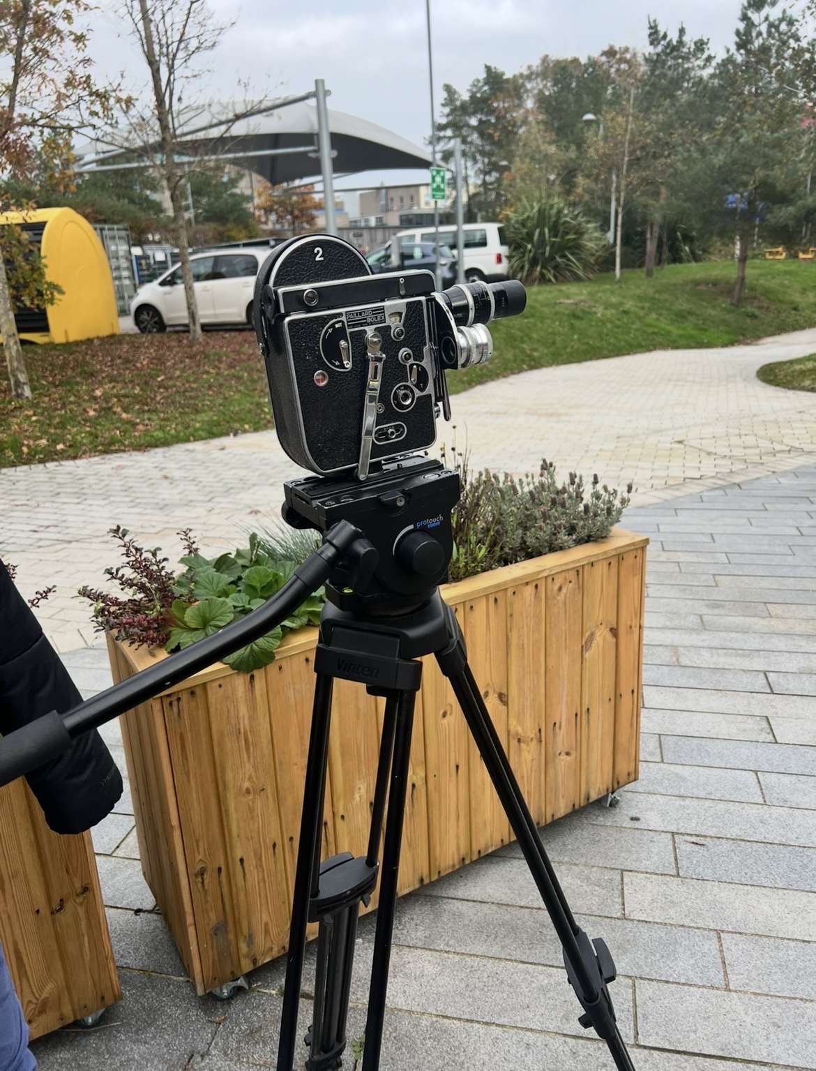 A Bolex camera on a tripod set up in the plaza at the back of Arts University Bournemouth campus.