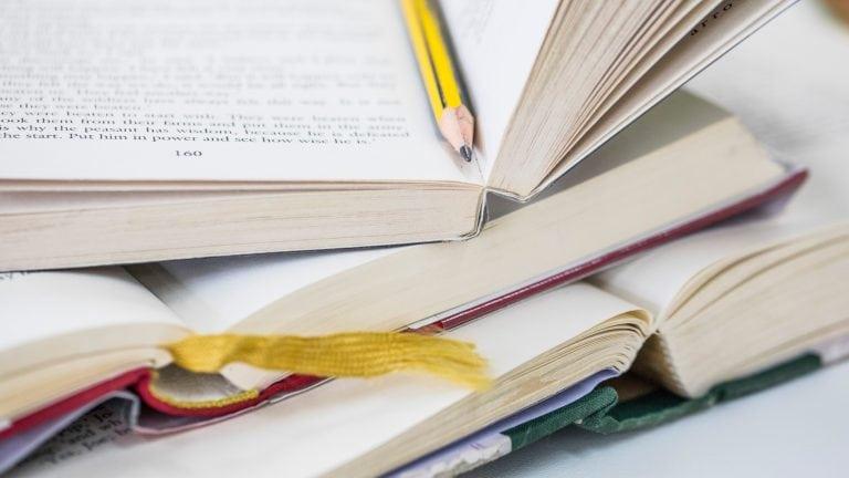 Close up of a stack of open books