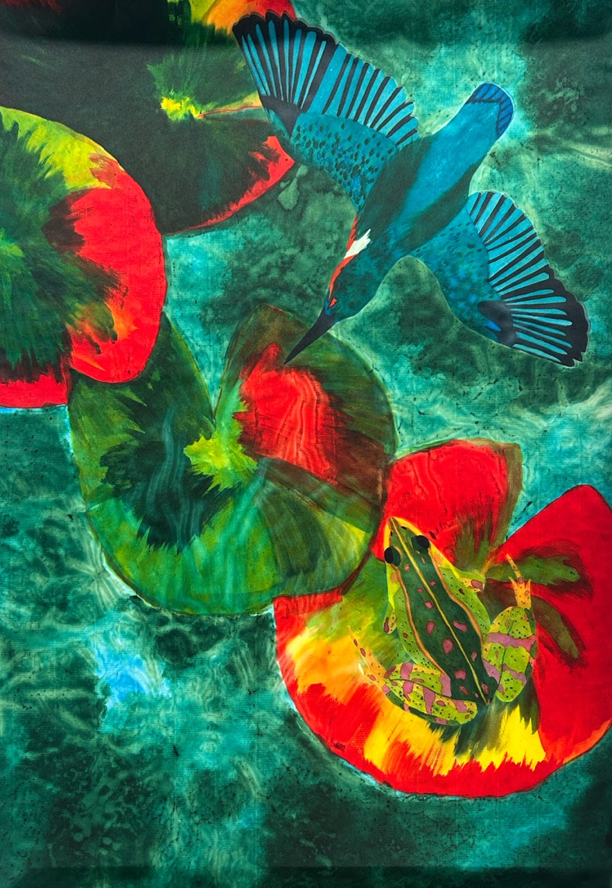 A vibrant illustration featuring a kingfisher flying above large, multi-coloured lily pads. One lily pad is red and green, while another shows a vividly patterned frog resting on its surface, surrounded by shades of blue-green water.