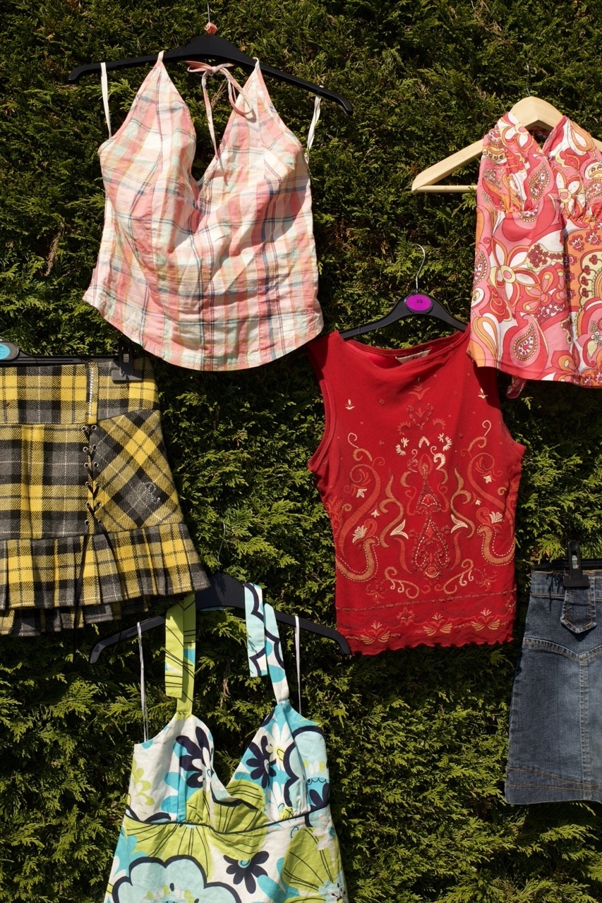 Colourful female fashion wear arranged on grass.
