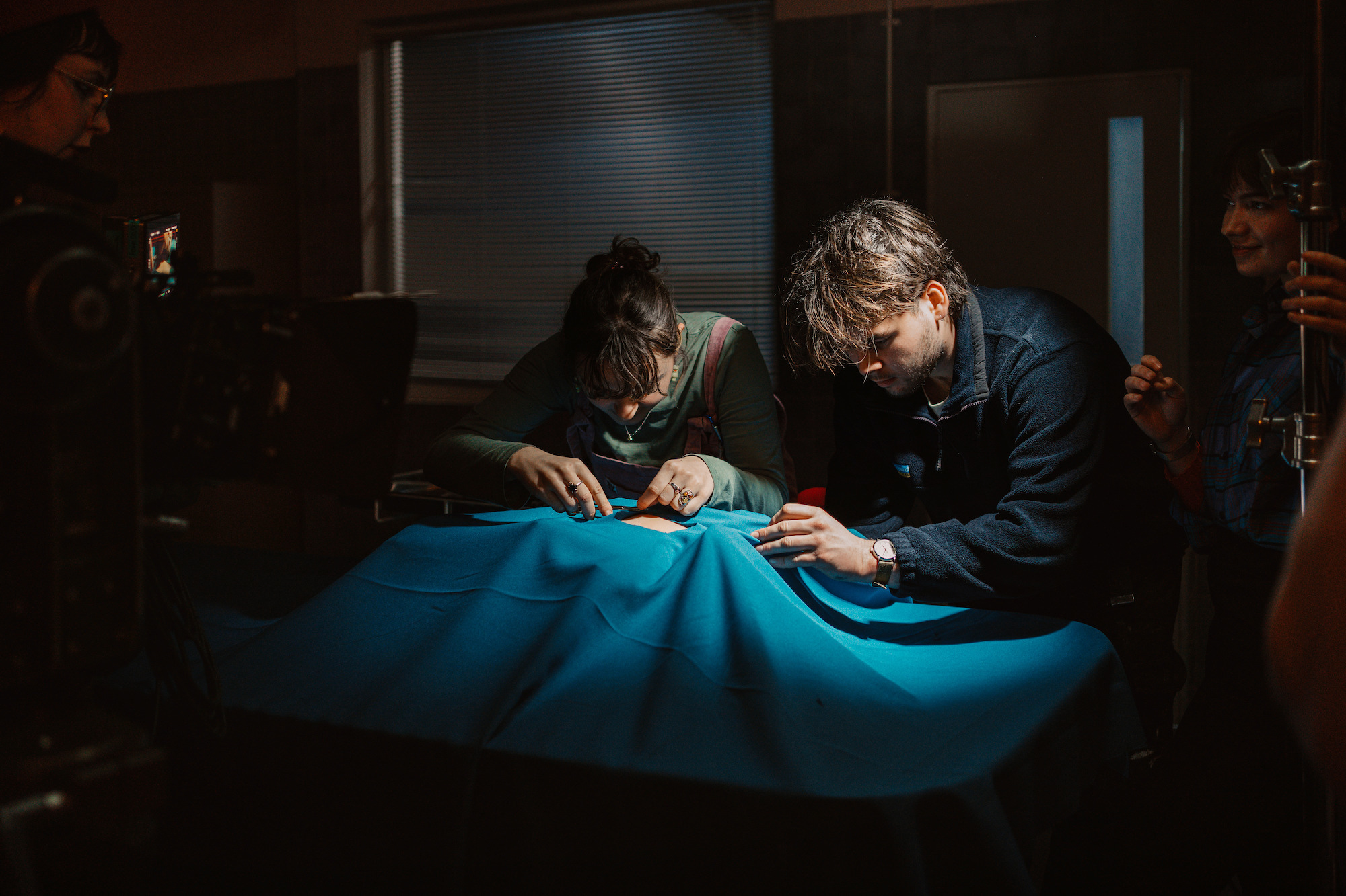 BA (Hons) Film Production students L Hancock and E Mainard adjusting a prop on the set of "Mourning Glories".
