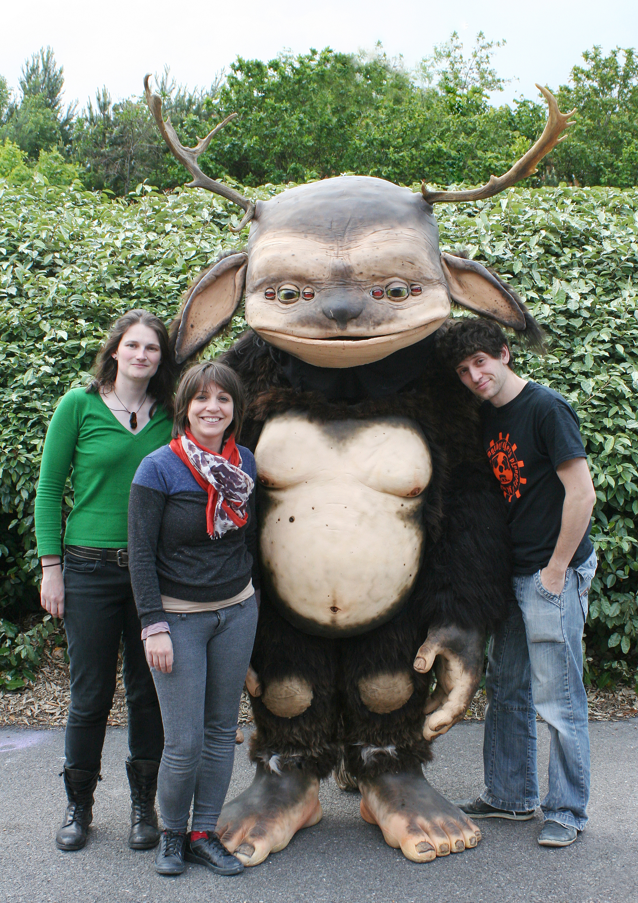 3 people with 6 eyed creature