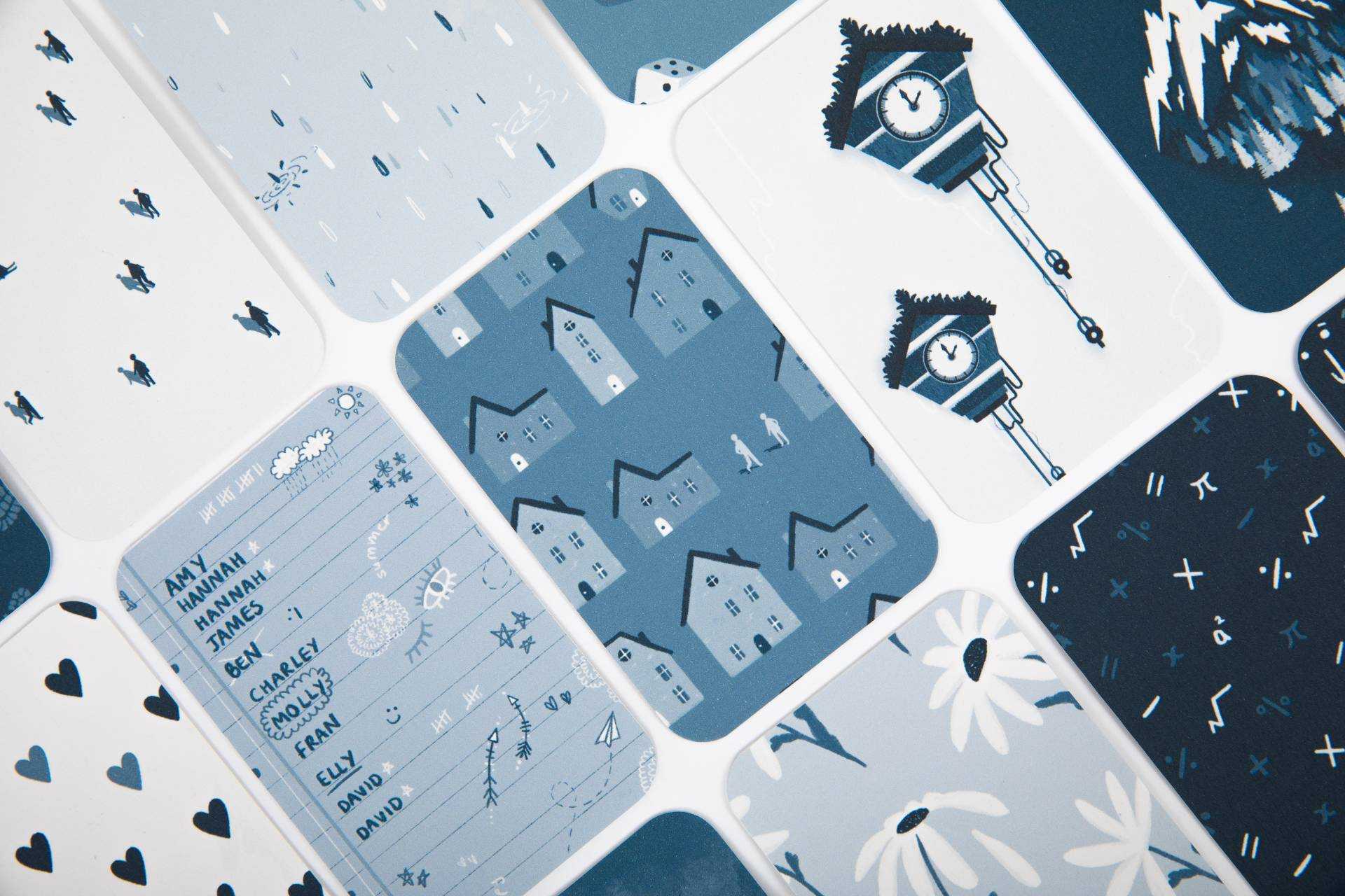A selection of card designs. Designs show rows of hearts, houses, a pair of cuckoo clocks, and a list of names.