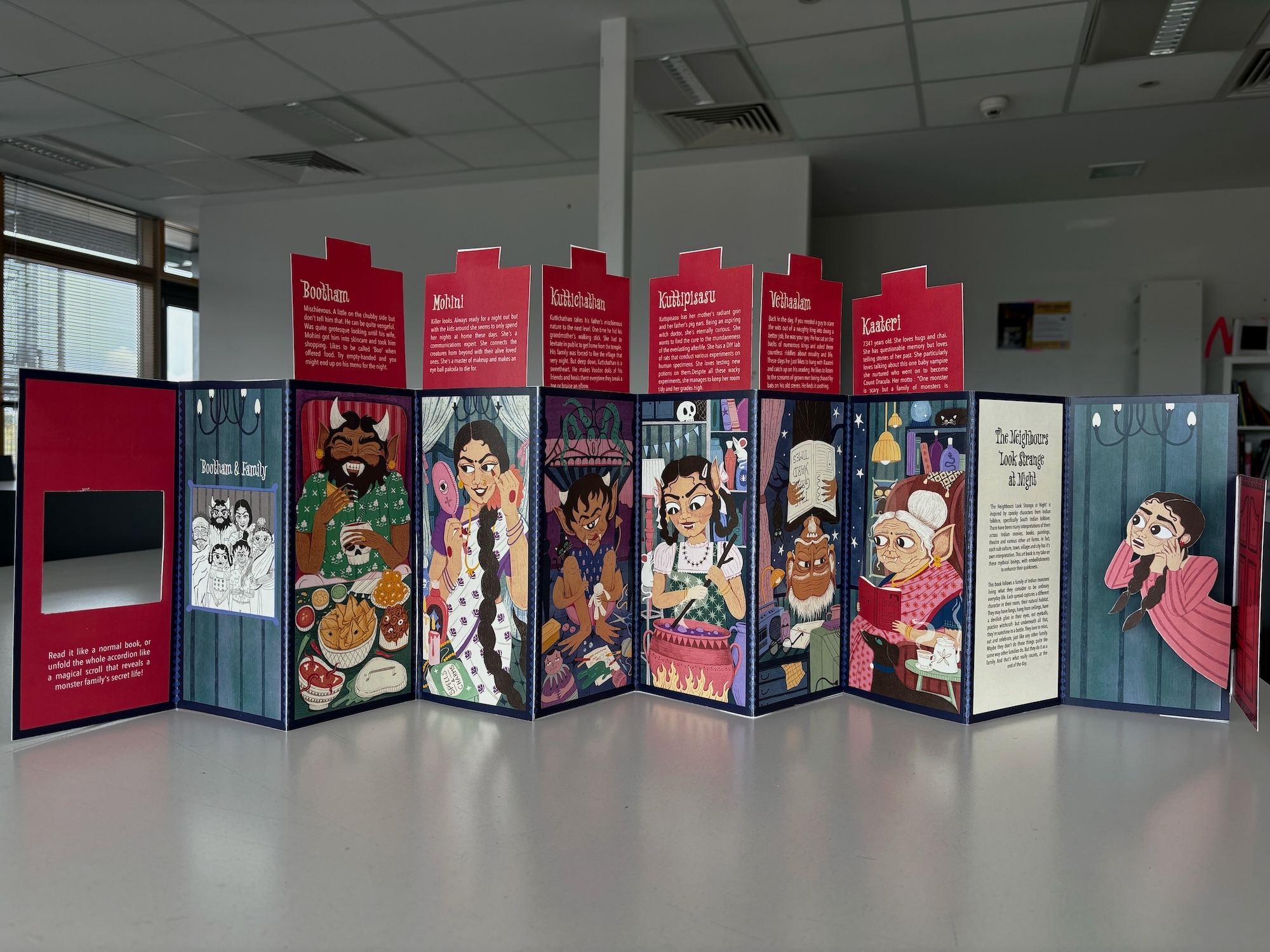 Accordion-style display panels with red headers and cartoon character illustrations on blue backgrounds in white indoor space.