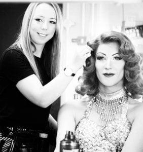 N. Allan applying hair and make-up to a performer.