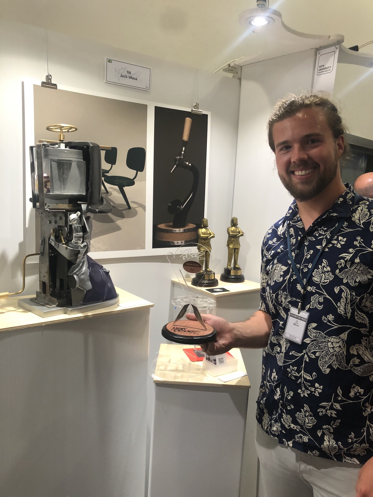 BA (Hons) Modelmaking student Jack Wase stands next to a model sweet dispenser on a pedestal.