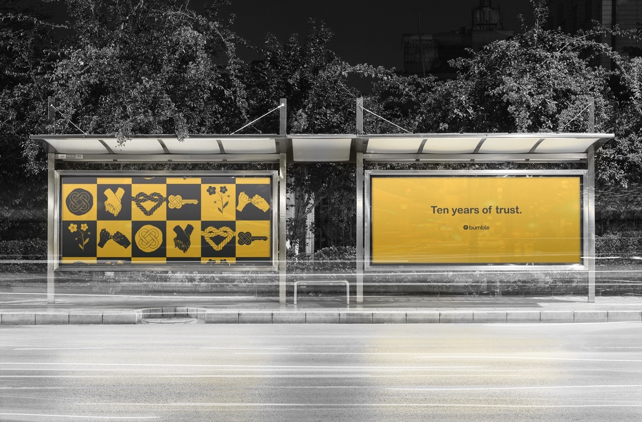 Bus stop advertising branding for the ’10 Years of Trust’ campaign, yellow and black graphics.