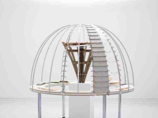 A model of a domed structure with an inverted pyramid structure visible inside it