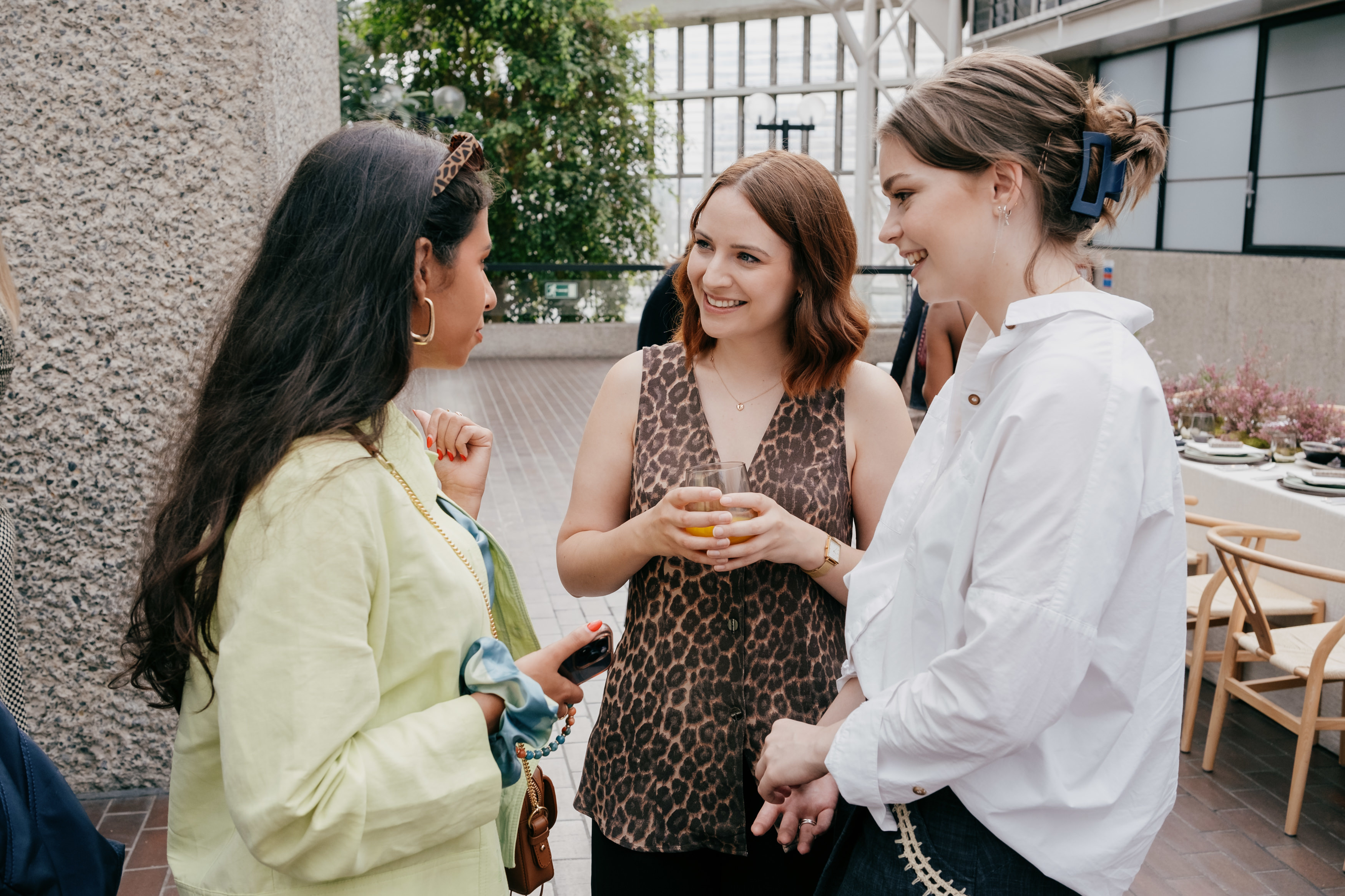 J Horton talking with two other attendees of the Net-a-Porter x King's Foundation launch event at the Barbican.