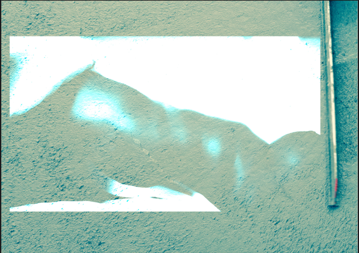 Abstract light artwork upon a white concrete wall.