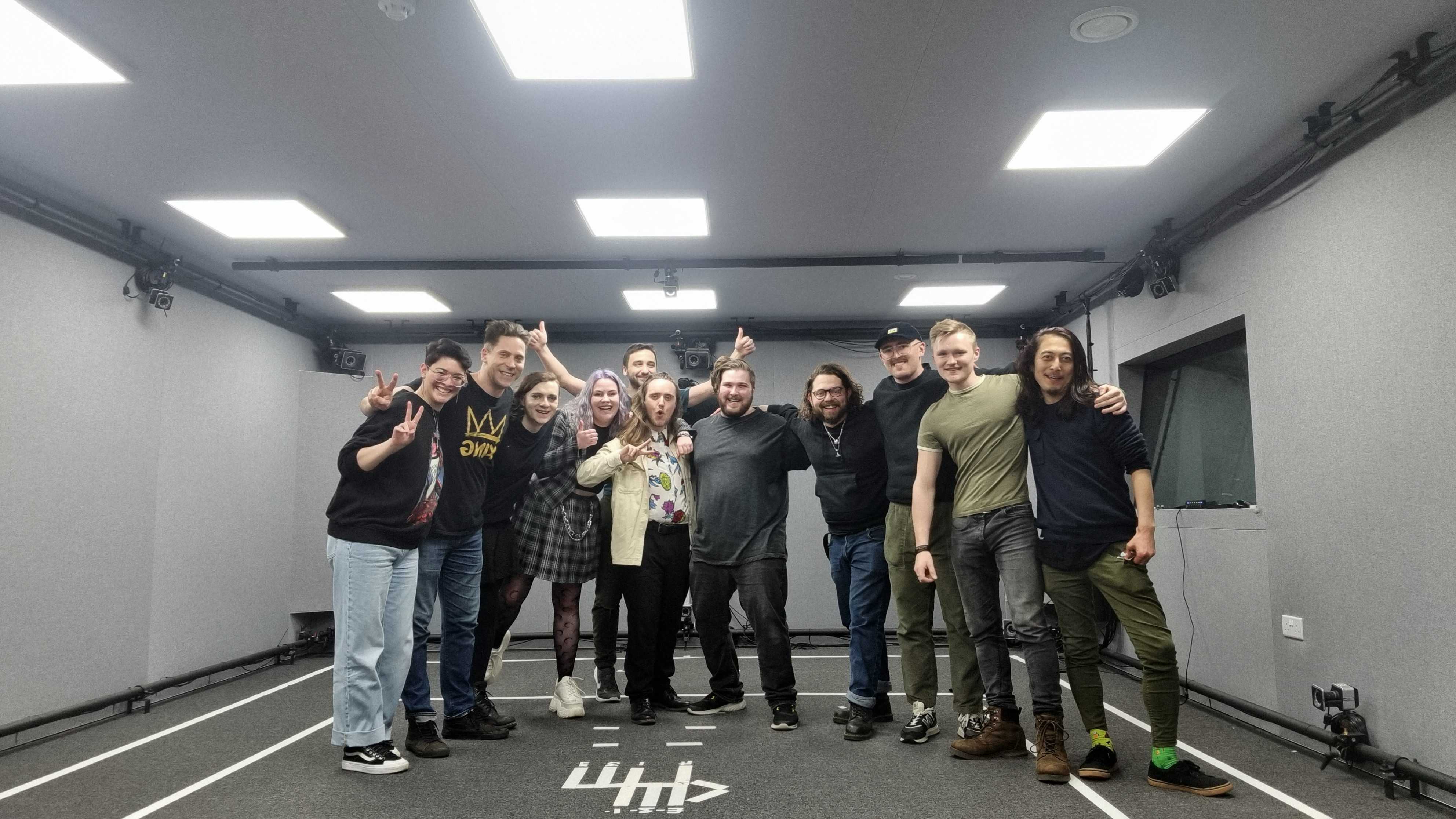 A group of people posing for the camera in a motion capture studio