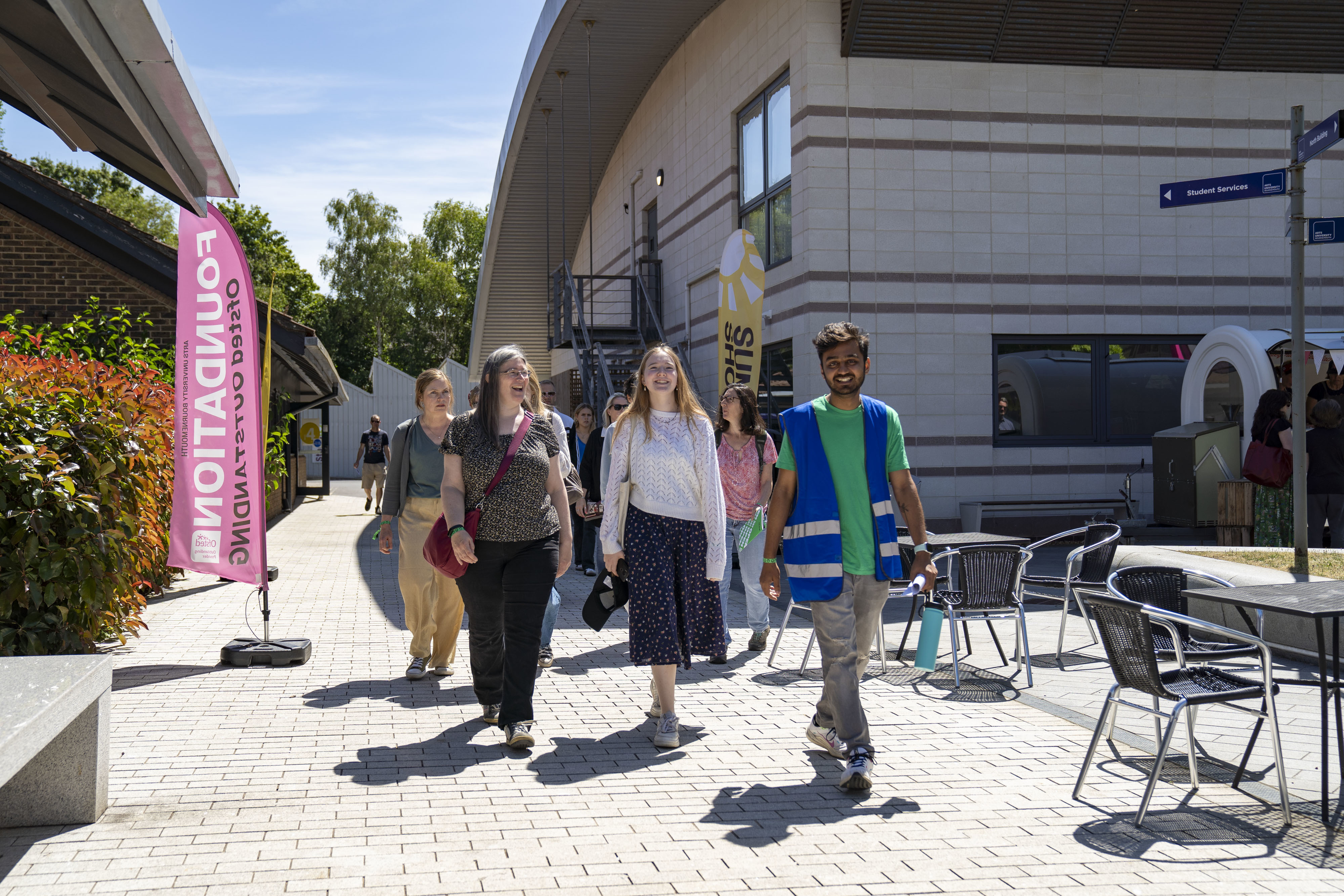 An AUB Student Ambassador leading visitors on a campus tour on an Open Day.