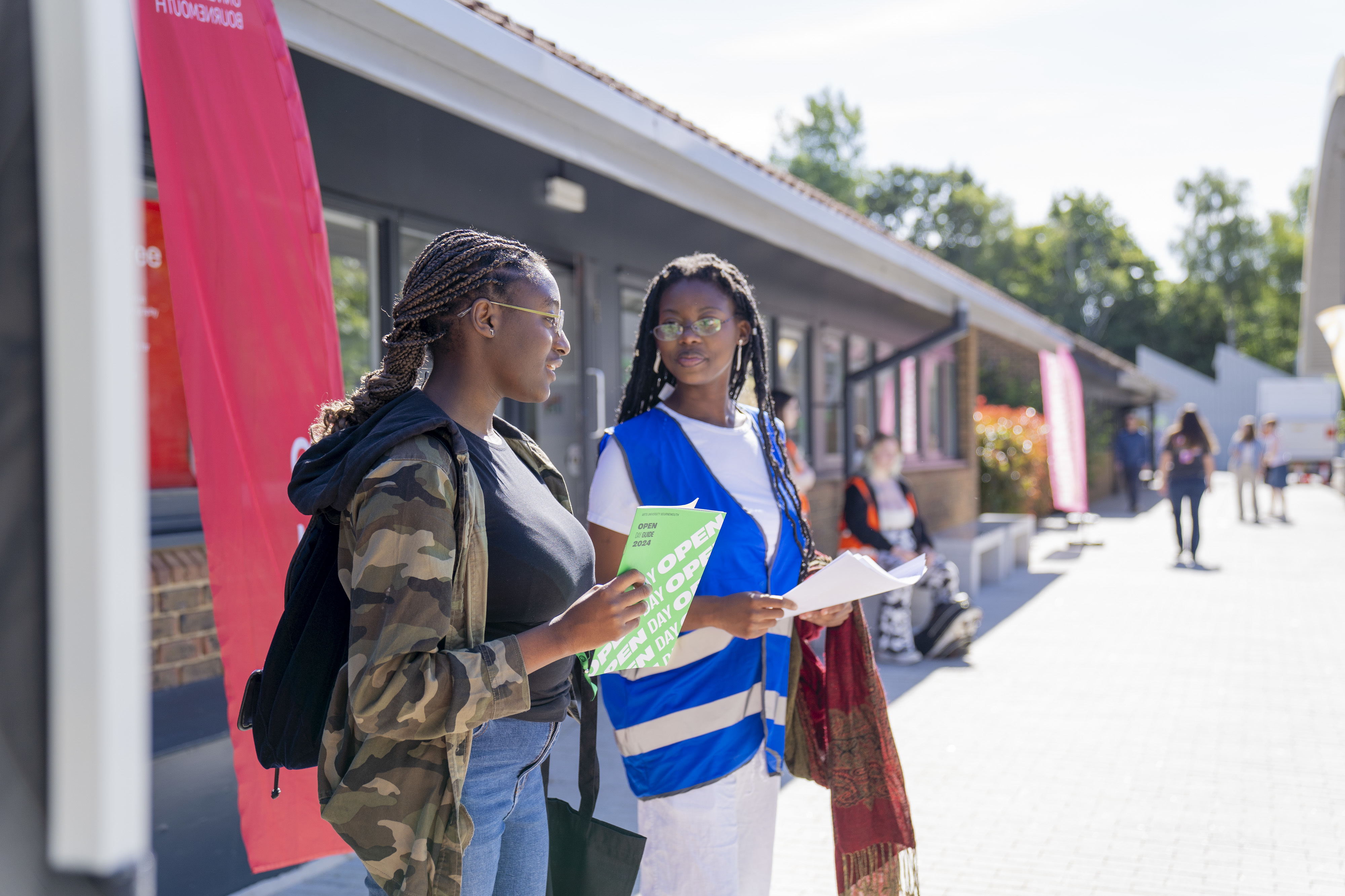 A student with a Campus Tour student ambassador outside in the courtyard.