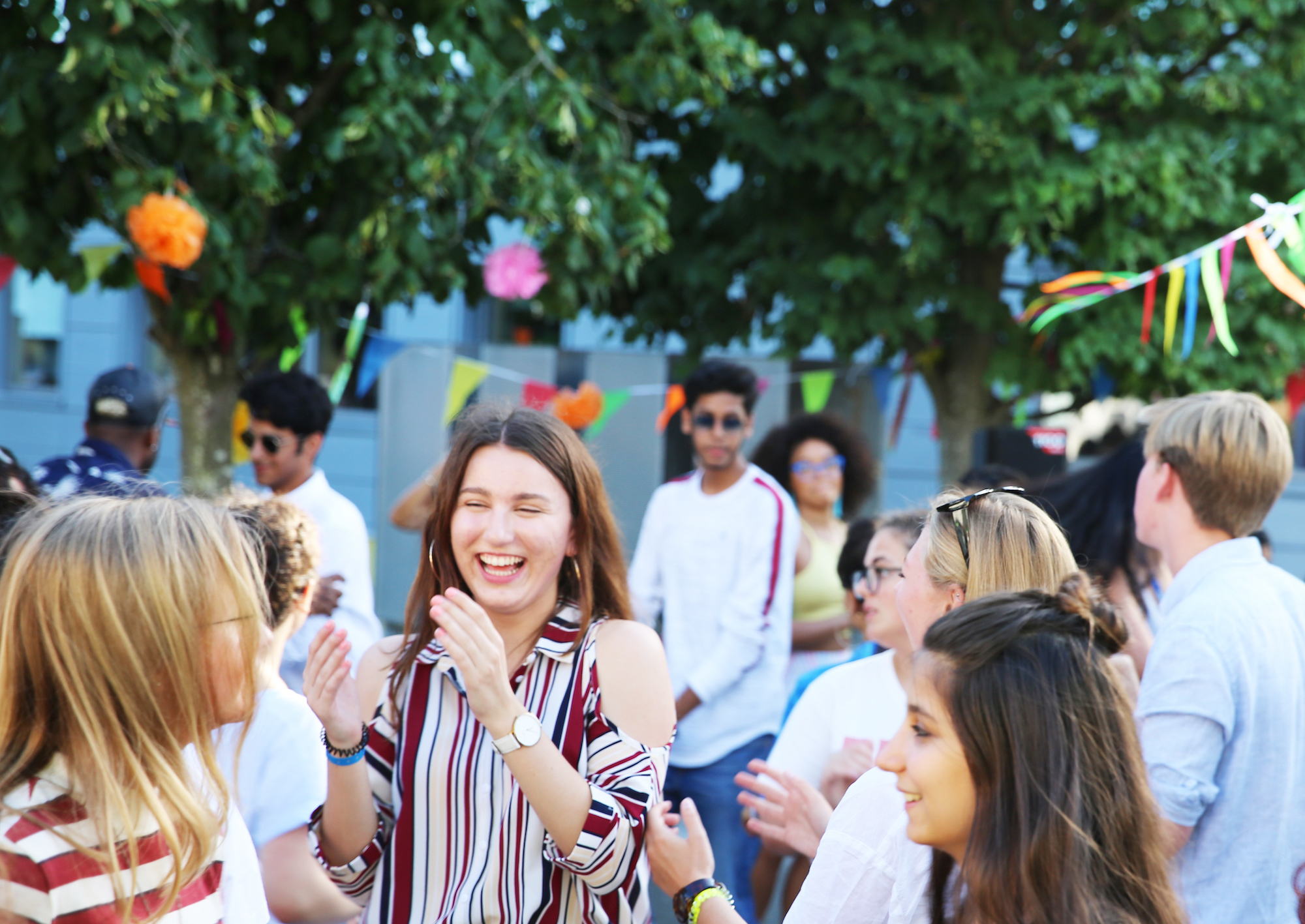 Students mingling at a summer event outside on AUB Campus.