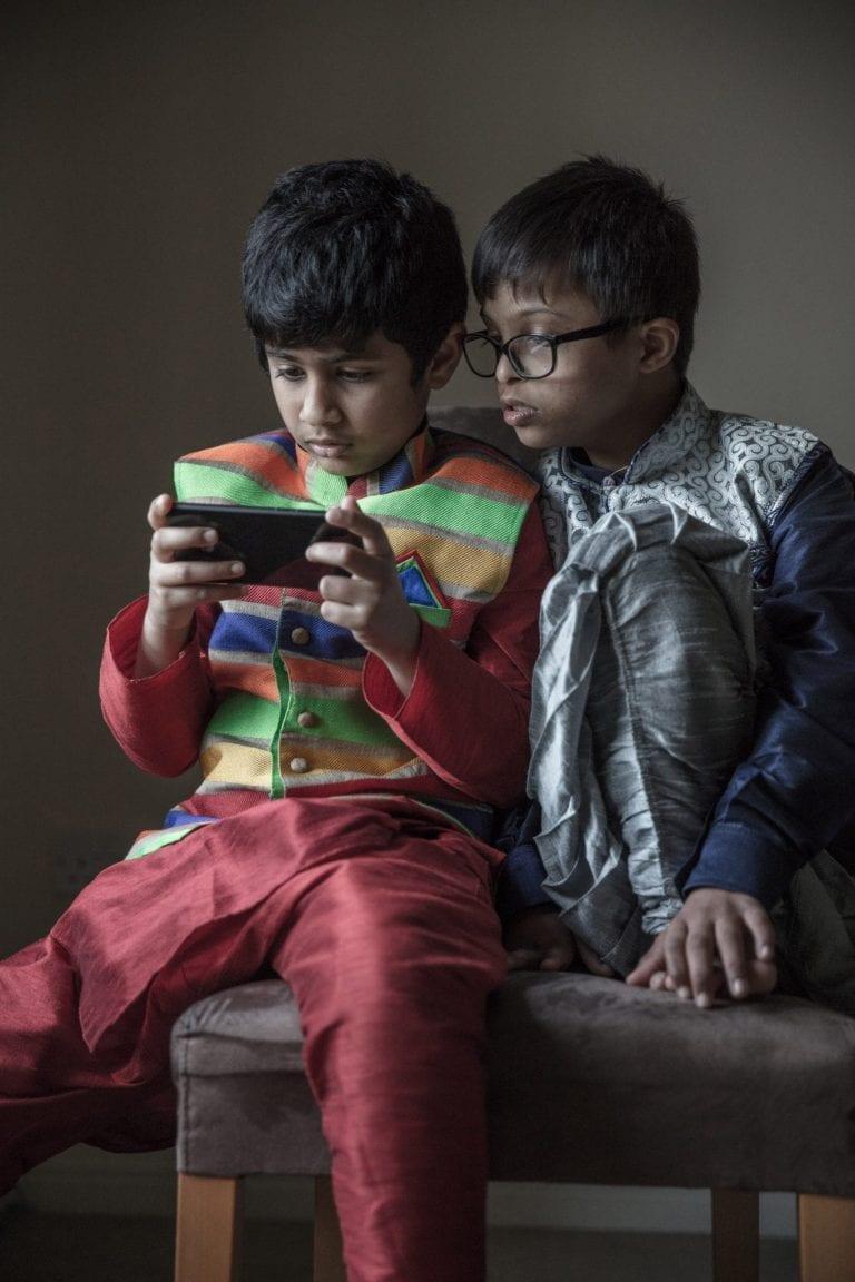 Boys playing on a phone
