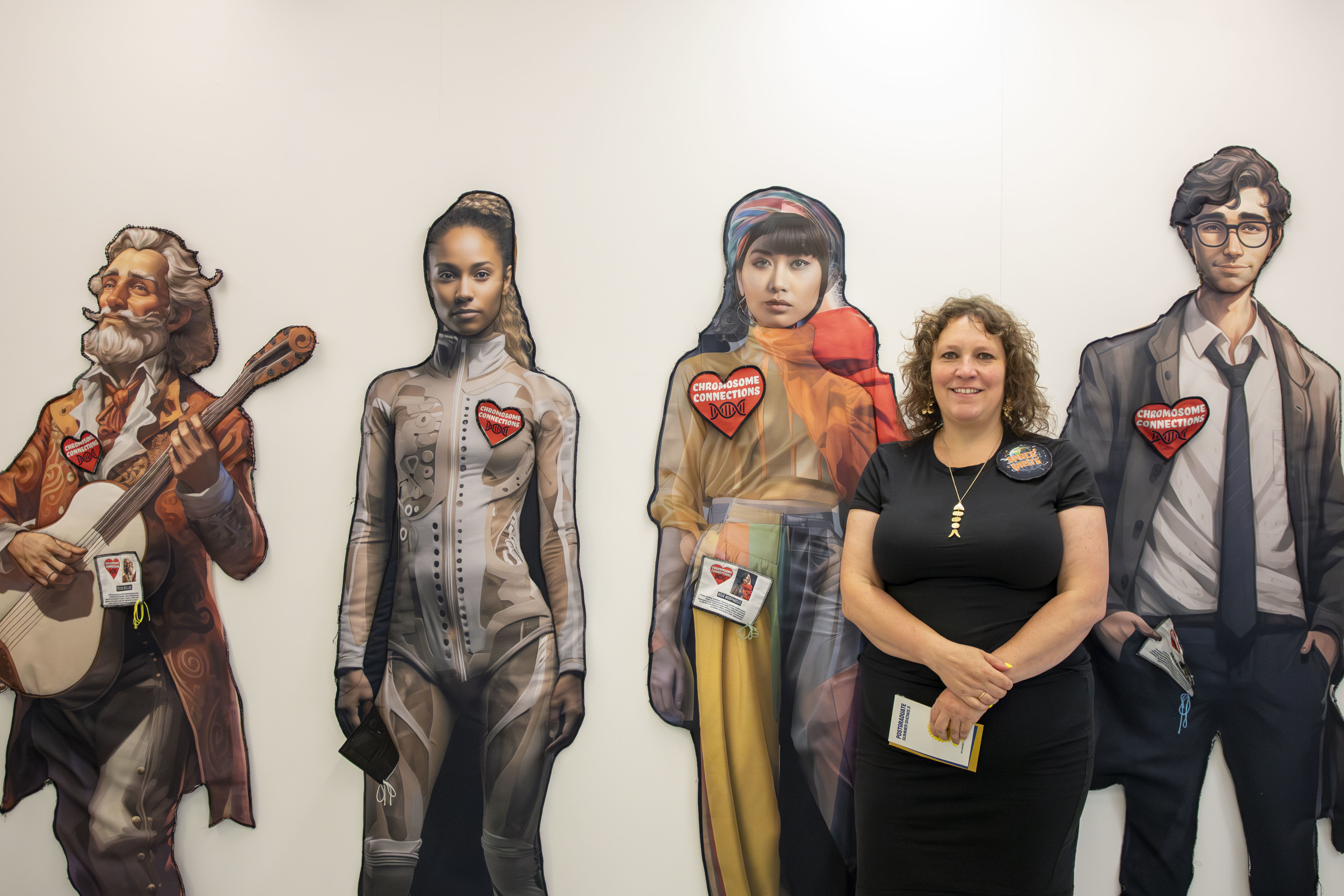 MA Fine Art student L Moro standing in line with four of her creations.