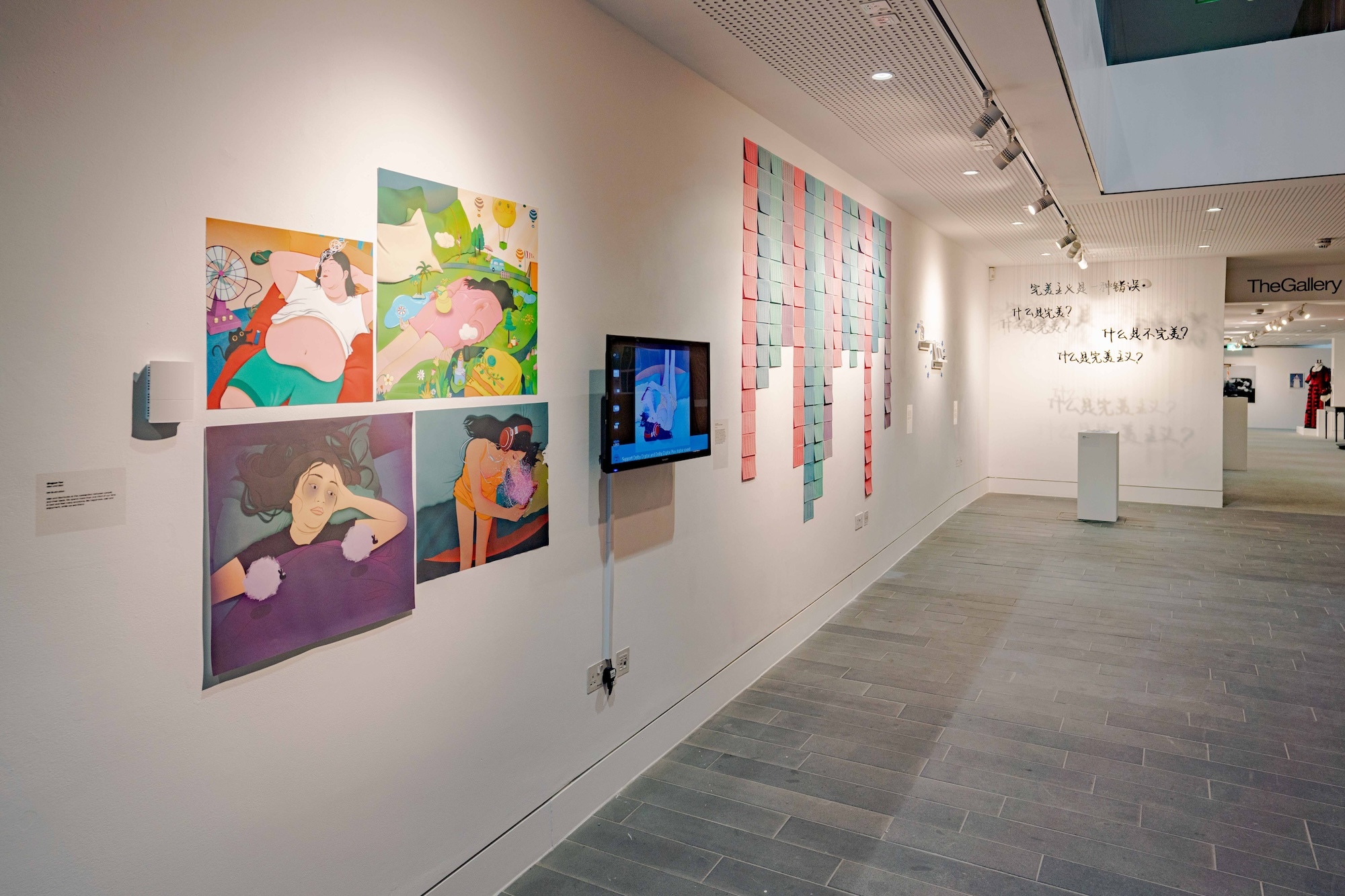 A selection of work on display at AUB's 2024 Postgraduate Winter Show. Four illustrations displayed in an uneven grid. A series of blue and pink calendar pages. A series of Chinese characters hanging from the ceiling.