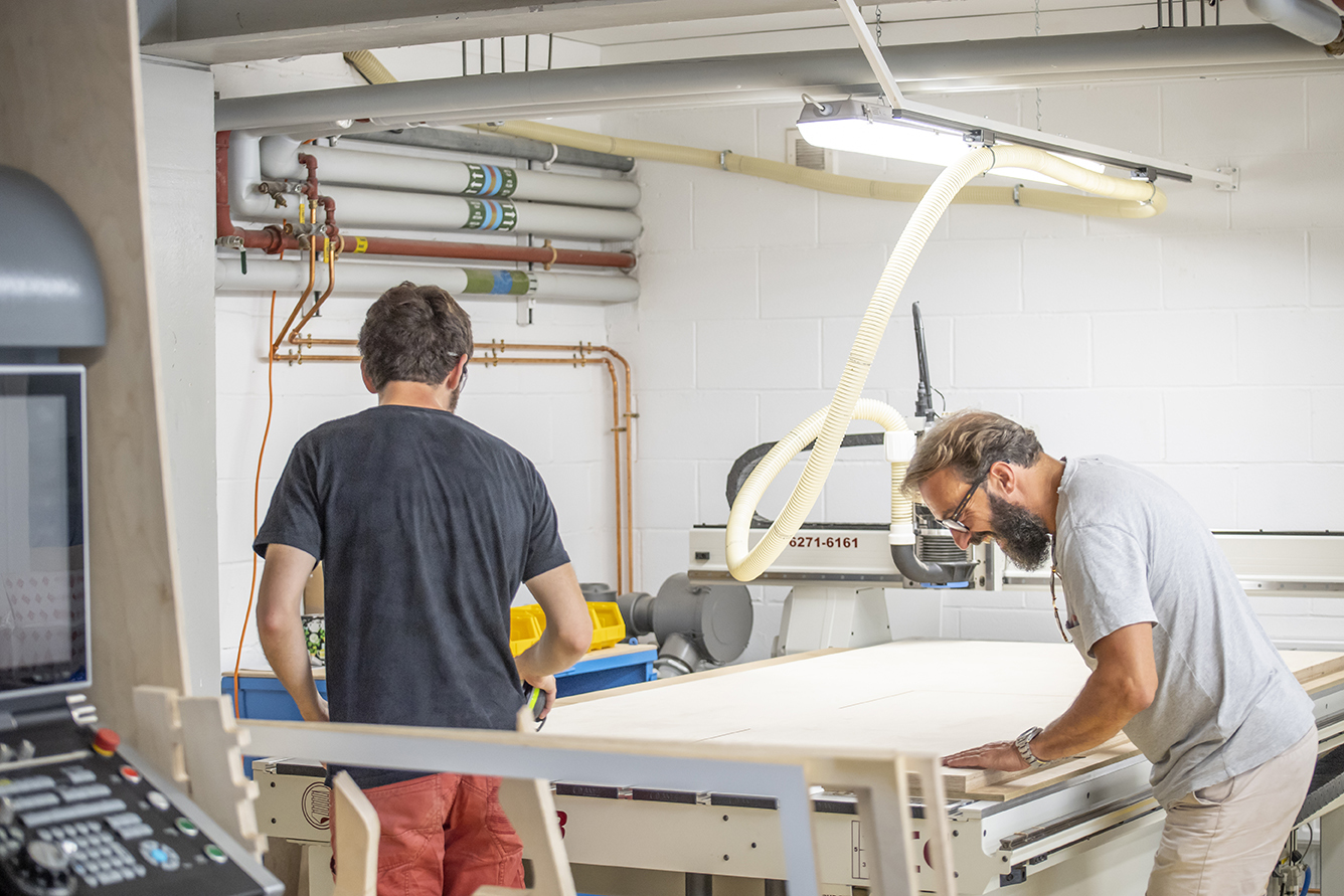 Two people working on the machinery in the Innovation Studio