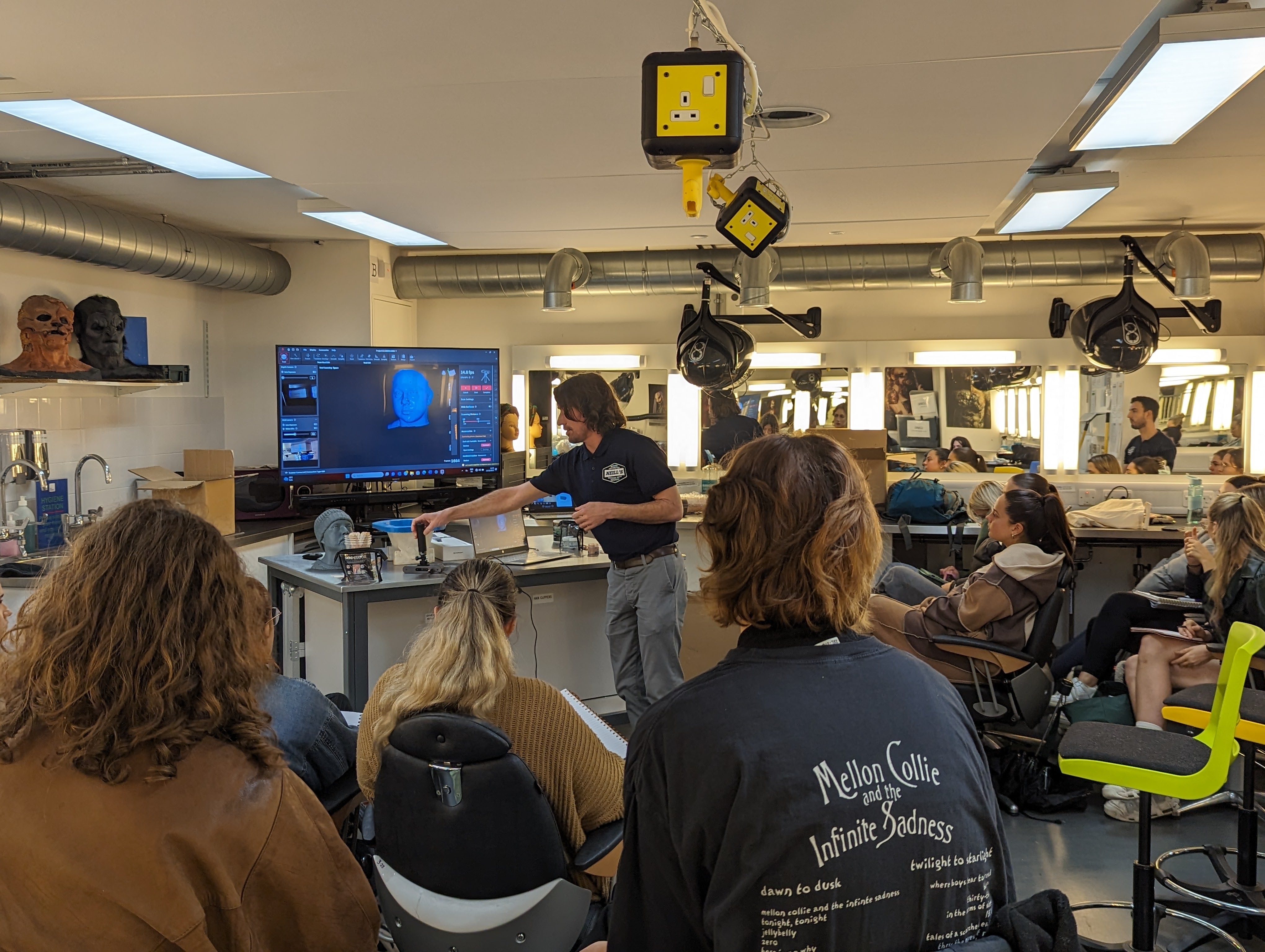 Tom and Matt demonstrating prosthetic props and technology to students.