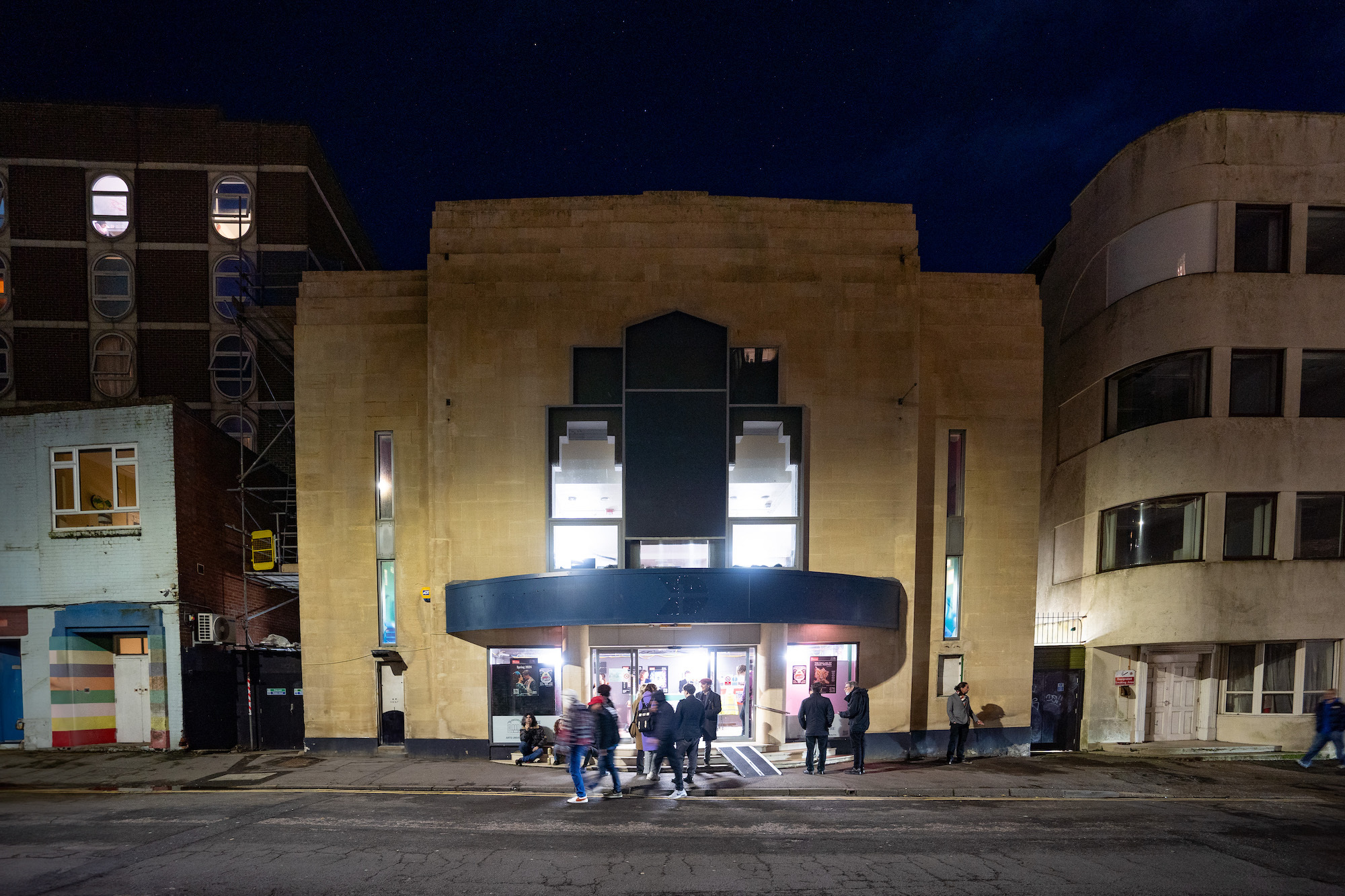 Outside of the Palace Court Theatre at night.