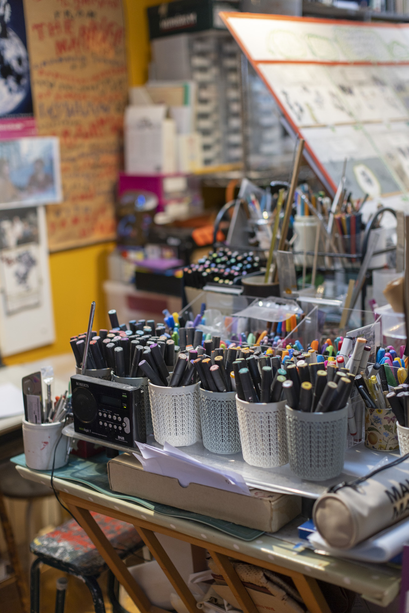 Pamela Howard's studio with many colourful pens in pen holders.